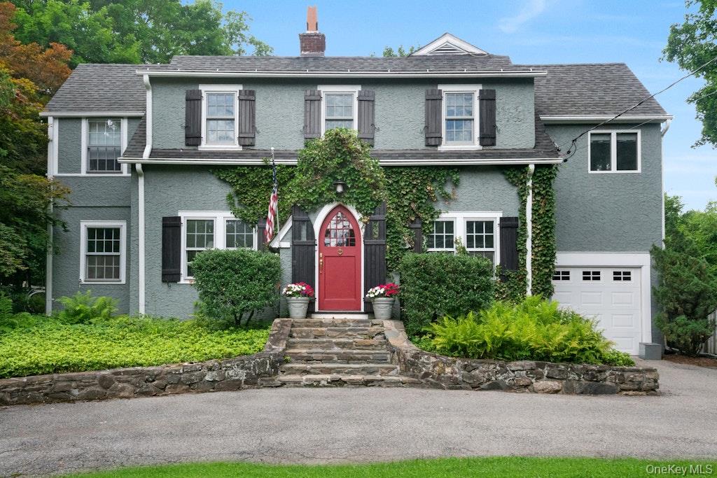 1926 Colonial with timeless character on a private and level half-acre, walkable to the train station and village in Chappaqua, NY. Circular driveway and classic curb appeal set the tone; inside, hardwood floors flow through an open, light-filled layout. The kitchen opens to a fireplaced family room with deck access, plus a formal dining room and a living room with its own wood-burning fireplace and screened porch. Upstairs, lives as a four-bedroom layout, the primary suite is a true retreat - en-suite bath with sauna and private balcony overlooking the yard with Koi pond plus an office/den, and a full hall bath. The partially finished lower level adds a playroom, wine closet, and storage. Brand new central air conditioning, plus a gas line on the street, offers possible future conversion.