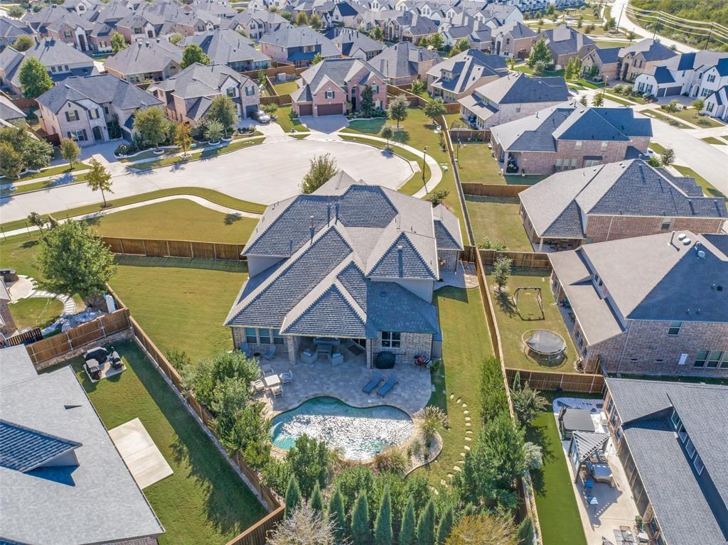 Stunning Shaddock Home situated on a HUGE Cul-De-Sac Lot with a spacious side yard, Swimming Pool with tranquil water features and outdoor living space! Step inside through a dramatic two-story entry that sets the tone for the home’s open and inviting layout. A private study with French doors.
The chef’s dream kitchen is the heart of the home, featuring quartz countertops, a large island, commercial grade 6-burner cooktop, double ovens, and custom cabinetry with glass accent doors perfect for entertaining or everyday family gatherings. Lightly hand-scraped wood floors that flow throughout the main level and the abundance of natural light. The primary retreat offers a peaceful spa-like escape with a soaking tub, frameless glass shower, and a spacious walk-in closet. A second bedroom downstairs adds flexibility for guests or multigenerational living. Upstairs, enjoy the game room and media room ideal for family fun and movie nights. Step outside to your private backyard oasis and outdoor entertainment area perfect for gatherings by the pool. A 3-car garage and a dream laundry room with extra counter space, sink, and a secondary pantry for large kitchen appliances add both function and style. Located just minutes from PGA Headquarters, top-rated Frisco ISD schools, dining, and shopping, this home truly has it all...elegance, location, and lifestyle.