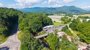 Nice restaurant located on Hwy 276 and the Pigeon River with a crossroad named Love Joy Rd. Building is approximately 4300 SF +/- with approximately 40 paved parking spaces. Land of approximately 4 acres +/- is partially in the flood plane. Building has a restaurant and a retail shop and a large unfinished basement. New heat and air units are  installed. Property has been leased to the same tenant for approximately 20 years.