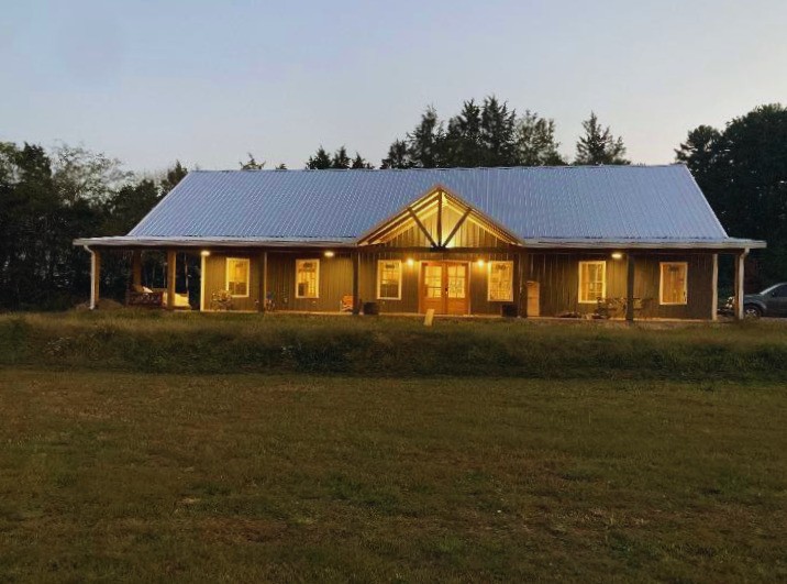 Privacy meets convenience in this beautiful Belvidere home tucked away on a quiet dead-end road—yet less than 20 minutes to town. Offering approximately 3,000 sq ft, this home features 9’ ceilings throughout, with a stunning vaulted living room and kitchen accented by tongue-and-groove ceilings. The spacious kitchen boasts a massive 12’ island—perfect for entertaining—while a large bonus room adds flexibility for any need. Unwind in the evenings on the beamed porches complete with a swinging bed. Additional highlights include a storm shelter, conditioned storage room, office/flex room and dual fuel HVAC system. Truly a home that checks all the boxes!