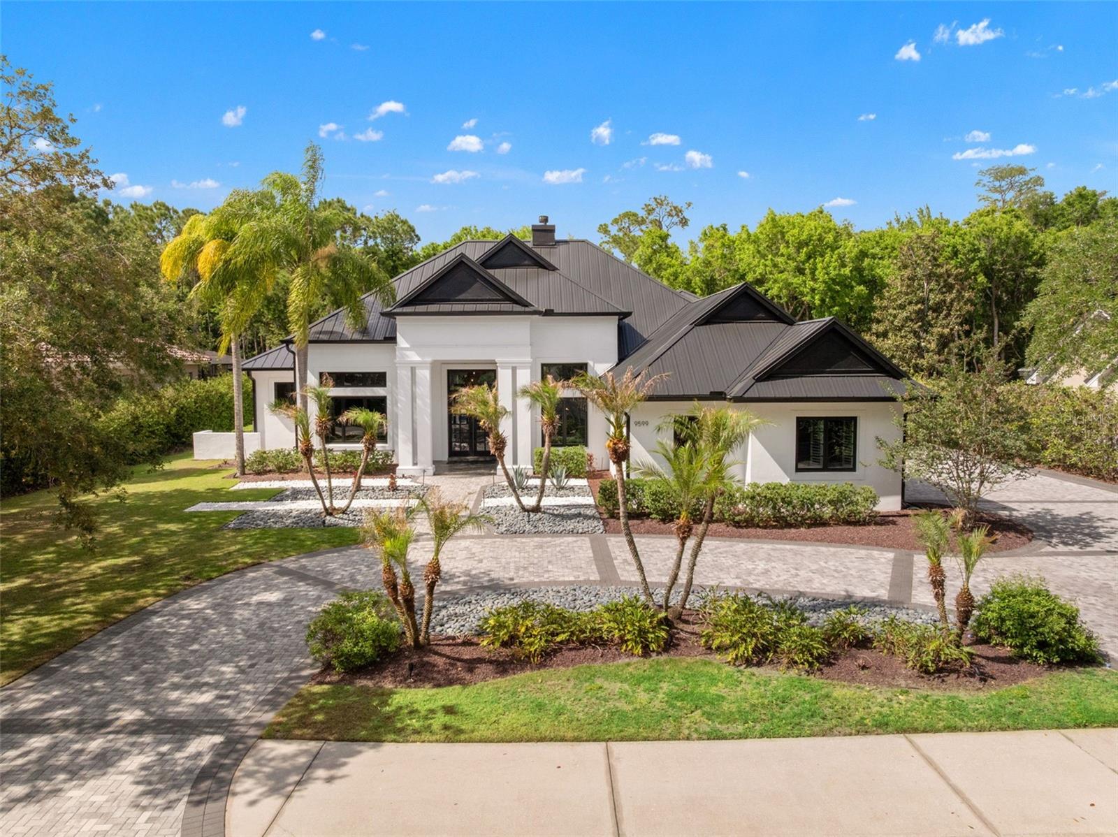 One or more photo(s) has been virtually staged. Welcome to 9599 Sloane, in Lake Nona Golf & Country Club, a beautifully updated residence that blends thoughtful design, quality upgrades, and a layout that truly lives as well as it looks. Offering 4 bedrooms, 4 full bathrooms, and 1 half bath, this home delivers elevated single-story living at its finest.From the moment you enter, natural light, soaring ceilings, and an effortless flow create an inviting yet refined atmosphere. The living room serves as a true focal point, featuring a coffered ceiling and custom built-ins that highlight the home’s architectural detail, while additional built-ins in the family room carry that cohesive, custom feel throughout.At the heart of the home, the kitchen is designed for connection and functionality, with an open-concept layout, high-end finishes, and a generous island that seamlessly anchors the main living and dining spaces.A standout feature is the oversized office with custom built-ins, both beautifully designed and highly functional, ideal for working from home or creating a quiet retreat.The primary suite offers a private escape, complete with a spa-like bathroom and dual walk-in closets, including an expansive custom closet with a cedar-lined closet tucked behind it, an unexpected detail that blends luxury with everyday practicality.Step outside to experience true Florida living. The backyard is designed to impress, featuring a saltwater pool, covered lanai, and a fully equipped summer kitchen (2023) with an oversized grill and pizza oven, perfect for effortless, year-round entertaining.Major upgrades provide exceptional peace of mind, including a new metal roof (2026), whole-house Generac generator (2025), most new windows (2022), and two Trane HVAC systems (2022).Additional highlights include a 3-car garage with epoxy floors (2025), a new driveway (2023), and refreshed landscaping that enhances the home’s clean, finished curb appeal.Ideally located just minutes from Lake Nona’s top-rated schools, Medical City, dining, and golf, this home offers the perfect balance of luxury, lifestyle, and long-term value.