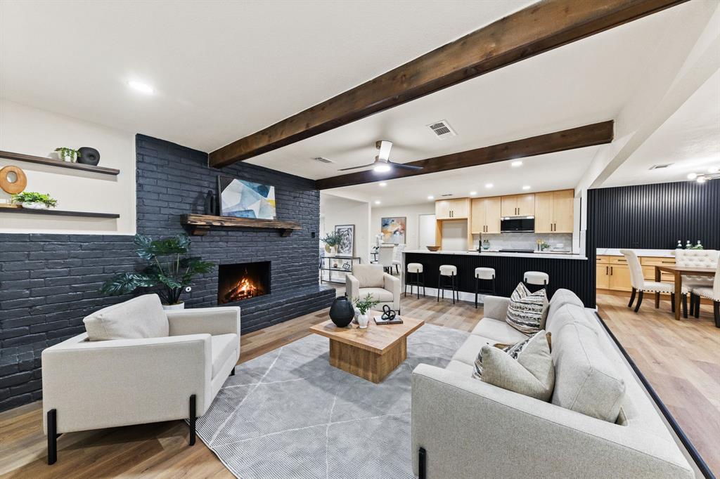 STUNNING fully renovated 3-bedroom, 3-bath, 2,086 sq ft home in a highly desirable North Bedford location! From the layout to the finishes, this open-concept, split-bedroom home has been upgraded in every way. The complete interior and exterior remodel includes a new roof, new windows, custom cabinetry throughout, LVP flooring, carpet, fresh interior and exterior paint, quartz countertops, LED recessed lighting, matte black fixtures, and more.The large living room offers built-in shelving, cedar beams, and custom wood accents perfect for entertaining. The chef-quality kitchen features waterfall island, custom natural wood cabinetry with soft-close hinges, quartz countertops, and stainless steel appliances.The spacious primary bedroom includes two walk-in closets and recessed lighting. The spa-worthy ensuite bathroom showcases dual vanities, custom cabinetry, quartz countertops, and a spa-inspired walk-in shower suite with a free-standing tub, multiple shower heads, wands, and a rain head. A secondary private suite offers its own oversized soaking tub. The third bedroom and fully renovated guest bath add to the home’s appeal.The outdoor space includes mature trees and a large backyard ideal for relaxing or entertaining. Located minutes from parks, shopping, dining, and major roadways. Award-winning HEB ISD. Come see YOUR new home today!