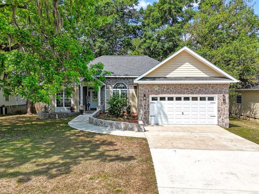 Location, Location, Location! Enjoy peace of mind with lots of new upgrades, including a new roof, newer HVAC system, new gutters, and a newer hot water heater. Move-in ready with major updates and low-maintenance curb appeal! This beauty offers a highly sought-after split floor plan and a spacious open-concept layout—perfect for modern living and entertaining. The durable stone and hardie board exterior provides long-lasting, low-maintenance appeal buyers love - making this home as practical as it is attractive.  The inviting living room features a cozy gas fireplace, elegant crown molding, and trey ceilings, creating a warm and upscale atmosphere. The kitchen combines style and function with a bright breakfast area, pantry, and ample counter space, perfect for everyday use or hosting guests. The primary suite is spacious and features high, trey ceilings. The additional 2 bedrooms provide plenty of space for guests or family.  Those bedrooms share a central bathroom. Relax or entertain outdoors on the private deck, ideal for gatherings or quiet evenings. Conveniently located just minutes from shopping, dining, schools, and everyday amenities, this home offers the perfect blend of comfort, convenience, and value—a must-see for today's buyers!