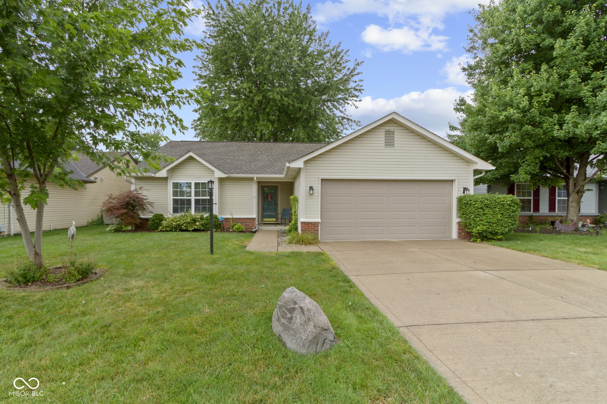 Welcome to this charming 3-bedroom, 2-bath ranch in desirable Sterling Green located on a private, fully-fenced, wooded lot! Step inside to an inviting great room that features vaulted ceilings and a cozy wood-burning fireplace-perfect for relaxing or entertaining. The kitchen boasts tiled floors, a stylish backsplash, and a generous pantry for all your storage needs. Each bedroom features a walk in closet for tons of extra storage! Enjoy outdoor living on the spacious deck. With recent updates including fresh interior paint, new carpet, freshly painted exterior trim, a newer refrigerator (2022), and a roof replaced in 2020, don't miss this inviting home with timeless appeal and modern updates!