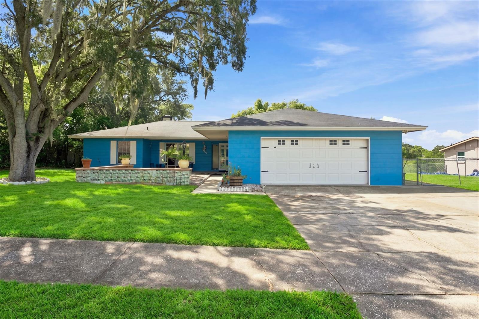 Welcome to a home where everyday comfort meets the Florida lifestyle! Set on approximately 0.40 acres with no HOA or CDD fees, this 3-bedroom, 2-bathroom home offers approximately 1,600 square feet of living space, along with the privacy and outdoor areas you have been looking for.From the moment you arrive, the oversized driveway provides plenty of additional parking, while the covered front porch creates a warm and welcoming first impression. Step through the inviting entryway and discover a home designed for comfortable living, complete with updated appliances and easy access to the outdoor spaces.The primary bedroom offers its own private retreat with a walk-in closet and a door leading directly to the screened-in pool area—perfect for enjoying a quiet morning by the water or an evening swim. The screened-in porch and enclosed in-ground pool create a relaxing setting where you can entertain guests, enjoy meals outdoors, or simply unwind while staying protected from the elements.Just beyond the pool area, step onto the elevated deck overlooking the open backyard. Stairs lead from the deck into the yard, creating a natural flow between the home’s outdoor entertaining spaces and the expansive property below. Whether you envision a garden, play area, space for pets, or your own backyard oasis, this generous lot offers plenty of possibilities.Two storage sheds provide convenient space for tools, lawn equipment, seasonal décor, and outdoor gear. Thoughtfully designed for both relaxing and entertaining, this home is ready for its next owner to make it their own.