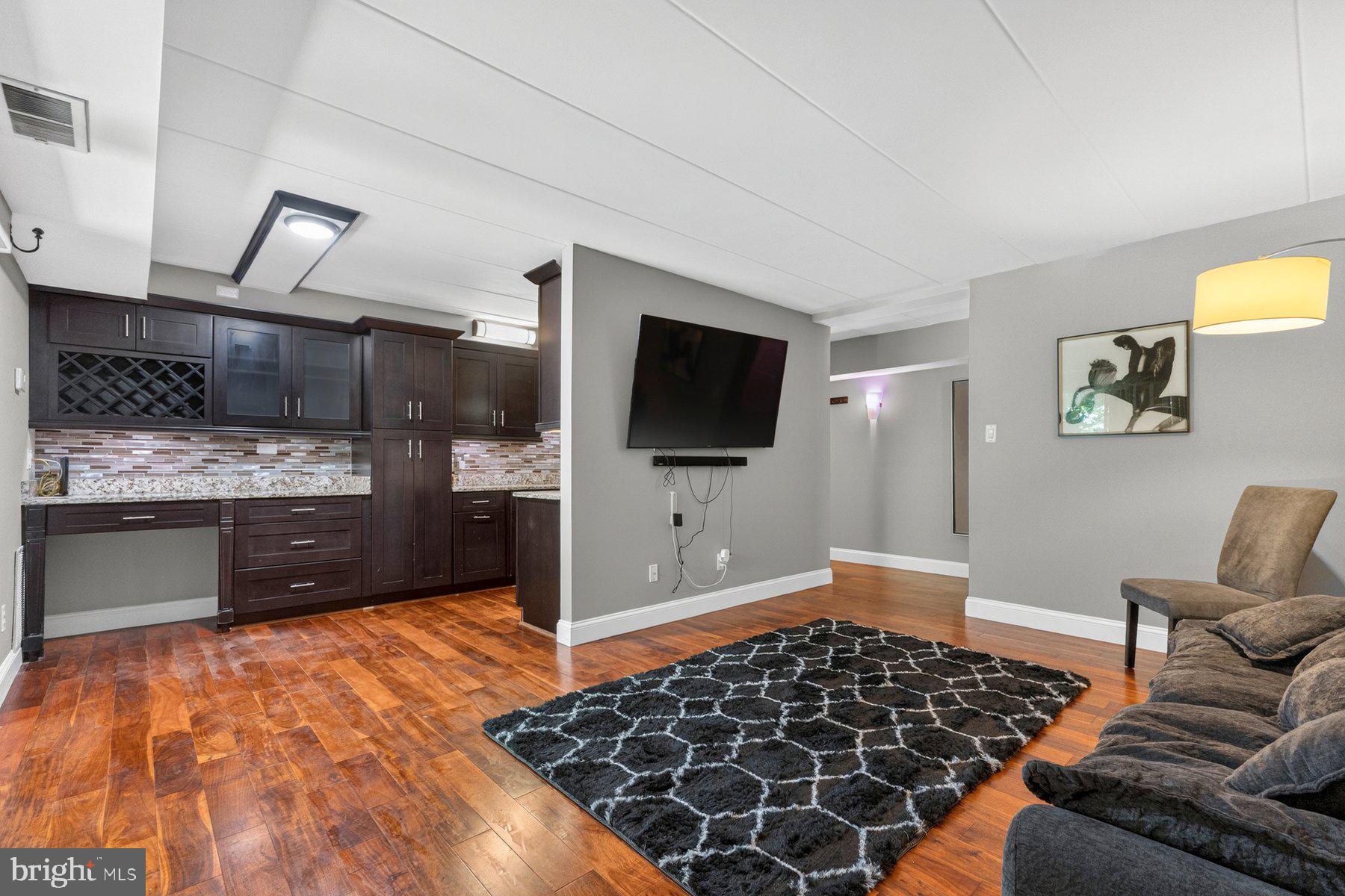 The Reston, VA Lifestyle You've Been Seeking! Welcome to 2330 Freetown Court #4/1B, a stellar and move-in ready 2 bedroom and 1 full bath condominium nestled within the desirable Glenvale community in the heart of Reston, offering the perfect balance of comfort, convenience, outdoor recreation, and access to one of Northern Virginia's most sought-after lifestyles. Freshly painted throughout in 2026 prior to market, this inviting residence showcases bright, light-filled living spaces, a functional open layout, and attractive hardwood flooring that extends throughout the kitchen, living room, hallway, and bedrooms, creating a warm and cohesive appeal. Large windows bring in abundant natural light while framing views of the surrounding mature trees and landscaped grounds. The spacious living room with access to the rear patio and community open space with a playground, benches and walking trail creates an ideal setting for both everyday living and entertaining, while the well-designed kitchen offers ample cabinetry, generous workspace, granite countertops and durable hardwood flooring that blends beauty and functionality. The sizable primary suite provides a peaceful retreat, and the flexible floorplan with a second bedroom offers options for guests, a home office, or fitness space. The bathroom is thoughtfully appointed with ceramic tile flooring and separate granite-topped vanities, adding an elegant touch to the home's well-maintained interior. Everyday convenience is enhanced by the in-unit washer and dryer, a private exterior storage room located immediately adjacent to the left of the residence, and a rear concrete patio that provides the perfect space for morning coffee, outdoor relaxation, or enjoying the peaceful surroundings. Commuters will especially appreciate being just steps from a community bus stop, providing easy access to nearby Metro stations, shopping, and employment centers. Beyond the home itself, residents enjoy all the benefits of the renowned Reston lifestyle, including miles of interconnected walking, jogging and biking trails, community pools, tennis and pickleball courts, parks, playgrounds, athletic fields, and easy access to nearby Lake Thoreau, Lake Audubon, and Lake Anne. Additional commuter advantages include convenient proximity to the Silver Line Metro stations, Dulles Toll Road, Route 7, Fairfax County Parkway, Reston Town Center, and Dulles International Airport. Shopping, dining, entertainment, farmers markets, waterfront experiences, and everyday conveniences are all just minutes away, making it easy to enjoy everything this vibrant community has to offer. The HOA/condominium fee includes water, sewer, gas and trash service, and permit/reserved parking passes adding additional value and convenience. Combining a move-in ready interior, attractive finishes, scenic surroundings, exceptional community amenities, everyday conveniences, and an unbeatable location close to major employers, transportation, recreation, and entertainment, 2330 Freetown Court #4/1B presents a rare opportunity to own in one of Northern Virginia's most established and welcoming communities. More to see and experience. Shows beautifully! See virtual video tour in listing. You'll be proud to call this "Home"!