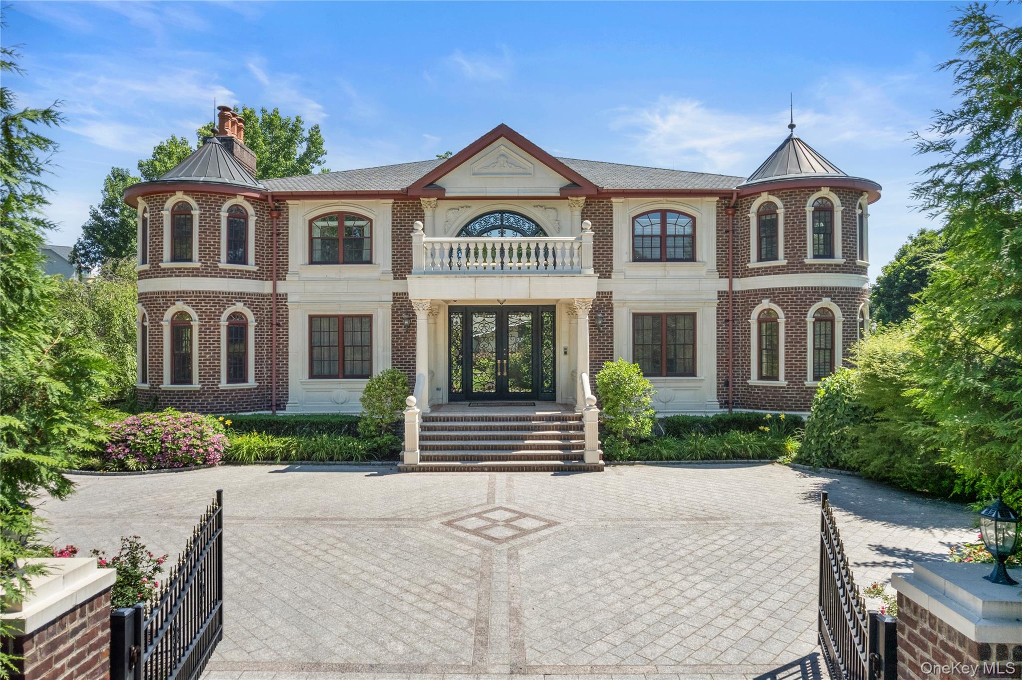 Welcome to 28 Whitney Circle, a breathtaking custom brick Colonial built in 2013 to the highest standards of modern engineering and timeless luxury. Nestled in Glen Cove’s exclusive Whitney Estates, this younger estate offers majestic water views of the Long Island Sound and perfectly balances master craftsmanship with turn-key modern convenience.Pass through the magnificent, bespoke Mexican wrought-iron entry doors into a grand foyer that sets a tone of true elegance. Throughout the sweeping living spaces, your eyes will be drawn to the intricate, hand-crafted Pakistani plasterwork and soaring ceilings. The home features gleaming, exquisite Brazilian Rosewood flooring that flows effortlessly from room to room, bathed in natural light pouring through premium Andersen windows.The gourmet chef's kitchen is anchored by hand-selected granite countertops and top-of-the-line appliances. Step outside into your ultra-private backyard oasis, complete with a resort-style private saltwater pool, perfect for summer entertaining against the backdrop of coastal breezes. Equipped with a private elevator and unparalleled architectural integrity, this Gold Coast sanctuary offers an unmatched modern lifestyle of privacy and sophistication.