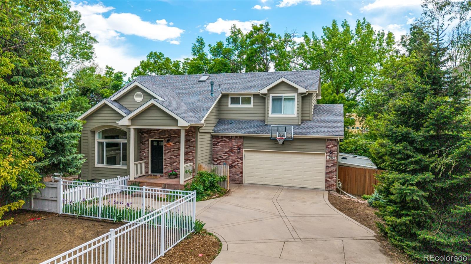 Tucked away at the end of a quiet private street in the heart of Central Boulder, this thoughtfully updated residence sits on an expansive 11,000 square foot lot, offering a rare sense of privacy, mature landscaping, and seasonal Flatirons views.Designed to maximize light and livability, the main level features vaulted ceilings, hardwood flooring, and an open layout connecting the kitchen, dining, and living spaces. Large windows frame the surrounding greenery, creating a natural connection to the outdoors. The kitchen features SS appliances, granite countertops, a farmhouse sink, a built-in bar area, and generous storage. A gas fireplace anchors the living space, while a powder room and spacious laundry room complete the main level. Sliding doors open to a newly redone deck, extending the living space outdoors.Upstairs, the primary suite offers vaulted ceilings and abundant natural light. The en-suite bath includes a soaking tub, walk-in shower, dual vanities, and a private WC, complemented by a custom walk-in closet with a center island. A mini-split system enhances comfort in the primary suite, in addition to central air conditioning. An additional bedroom and full bathroom complete the upper level.The finished lower level includes a spacious family room with built-ins, a full bathroom, and two additional bedrooms.The outdoor setting defines the property—an inviting, private oasis within the city, with multiple areas for gathering and relaxation. A new deck, covered pergola, and a separate firepit area are set within a beautifully landscaped, usable yard with mature trees, a water feature, irrigated garden beds ideal for herbs, vegetables, or seasonal blooms, along with a chicken coop and shed.Recent improvements include a newer roof and the fully redone deck.Located minutes from Ideal Market, neighborhood shops, and dining, this home offers a rare combination of privacy, outdoor living, and walkability in one of Boulder’s most sought-after locations.