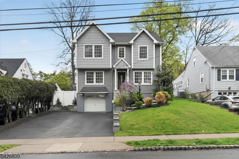 Welcome to this beautifully updated 3-bedroom, 2.5-bath home in the sought-after Cedar Grove community. Renovated in 2018, this move-in ready property offers a modern, open layout with thoughtful updates throughout.The main level features a bright front-to-back living area with a gas fireplace, recessed lighting, and a seamless flow for everyday living and entertaining. The kitchen includes modern cabinetry, stainless steel appliances, and a center island with seating. There is also a convenient half bath on the first floor. The second floor offers two additional bedrooms, a full bath, and a primary suite with its own en-suite bath. A finished basement provides flexible space for a rec room, office, or gym.Enjoy a fully fenced backyard with paver patio, landscaped grounds, and open lawn space. A detached 9x14 structure with electricity, heating, cooling, and a skylight is perfect for a home office or studio.Architectural plans for a first-floor addition and attic expansion are included. Additional features include a sprinkler system, landscape lighting, electric car charger, outdoor TV hookup, and security cameras.Conveniently located near parks, shopping, dining, well-regarded schools, major highways, and nearby NYC transportation options. Washer and dryer not included. (Playground not included.)