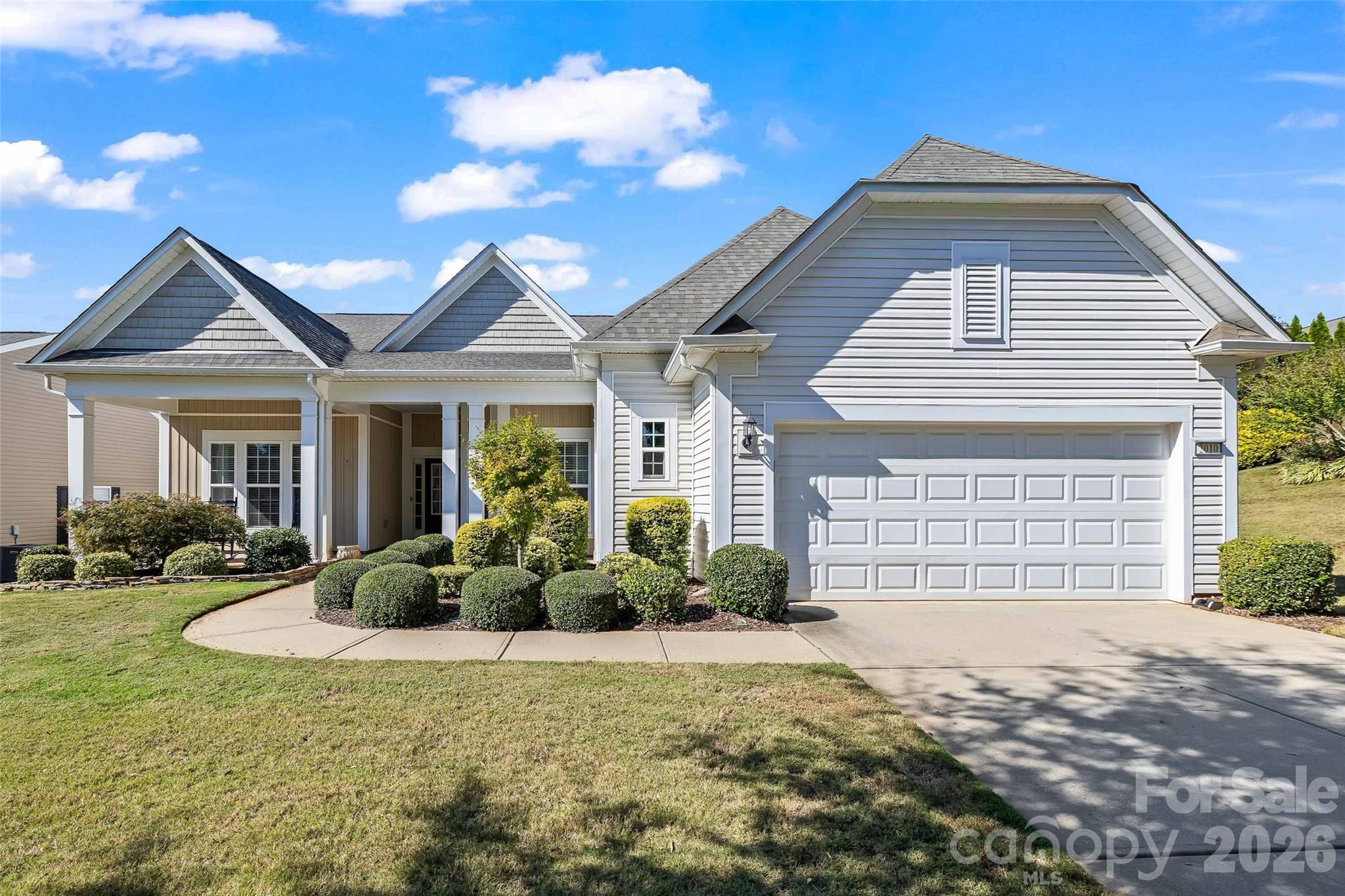 Beautiful upgrades, inviting gathering spaces and exceptional storage define this Cumberland Hall home in Sun City Carolina Lakes! Built in 2015 and freshly painted, this desirable home features custom hardwood flooring throughout, crown molding and elegant trim details. The spacious living area is anchored by a fireplace and flows into the dining area, creating a welcoming setting for entertaining. The kitchen impresses with white cabinetry, granite countertops, a center island, stainless steel appliances, gas cooktop and new dishwasher. Cabinet rollouts and a pantry customized by Closets by Design keep everyday essentials beautifully organized. The four-season sunroom offers another inviting gathering space, with abundant windows bringing in natural light and backyard views. Step outside to the attractive paver patio, perfect for outdoor dining or relaxing amid the surrounding landscaping.The spacious primary suite offers a spa-inspired bath with a luxurious steam shower, dual sinks, a built-in seated vanity and convenient cabinet rollouts. A walk-in closet customized by Closets by Design provides extensive shelving and thoughtfully arranged storage. Two additional bedrooms offer comfortable accommodations for guests, while a separate office provides a dedicated space for work or hobbies. A separate laundry room with cabinetry and counter space adds everyday convenience, while the built-in drop zone at the garage entrance keeps belongings neatly tucked away. An impressive garage extended by four feet provides valuable extra room for storage, hobbies or a work area. Additional highlights include an irrigation system and HVAC replaced in 2024. Enjoy Sun City Carolina Lakes’ resort-style amenities, including indoor and outdoor pools, a fitness center, tennis and pickleball courts, walking trails, community clubs and activities, plus the public Carolina Lakes Golf Club!