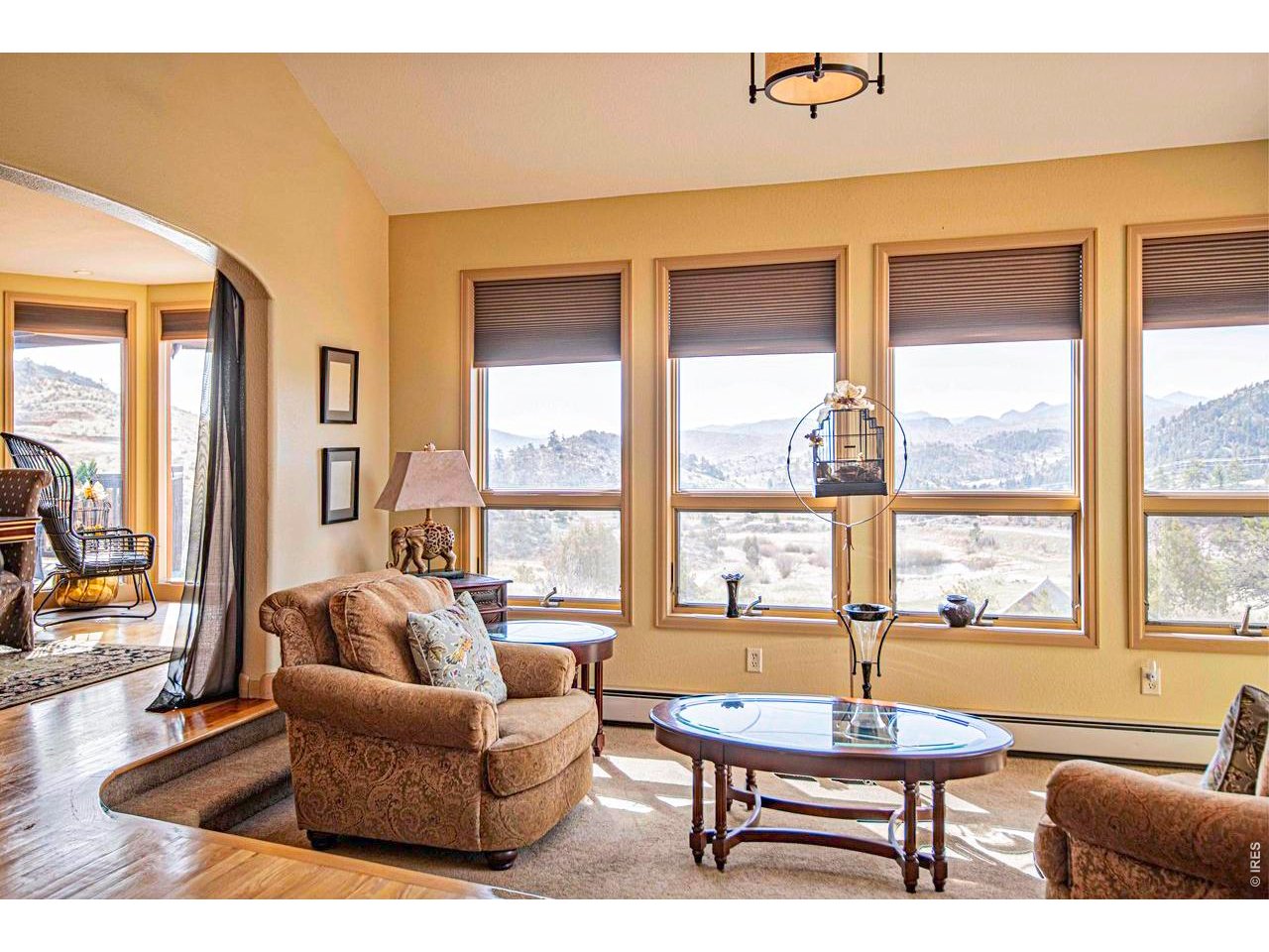 Discover a mountain home where exceptional craftsmanship, timeless design, and breathtaking scenery come together. Nestled on 1.48 acres in Glacier View Meadows, this beautifully maintained custom residence was built to a standard rarely found today. From its solid construction and thoughtful design to its tasteful updates and meticulous care, this is a home that has been cherished. Tall ceilings, dramatic walls of glass, and expansive wraparound decks frame mountain views while filling the home with natural light. With nearly 3,900 square feet, four bedrooms, and three baths, the spacious floor plan offers comfortable everyday living. The main living areas are warm and inviting, anchored by beautiful fireplaces and surrounded by panoramic views. The private primary suite offers a peaceful retreat with a sitting area, a two-sided fireplace, and a luxurious jetted soaking tub perfectly positioned to capture the surrounding landscape. The walkout lower level provides generous space for guests, recreation, hobbies, or multi-generational living. Throughout the years, the home has been thoughtfully updated while preserving the quality and character that only a true custom home can offer. Even the exterior reflects the pride of ownership, having been professionally painted with exceptional attention to detail, resulting in a finish that beautifully complements the home's mountain setting. Step outside to mature pines, impressive rock outcroppings, a tranquil pond, abundant wildlife, and some of Northern Colorado's most captivating sunsets and star-filled skies. Despite the peaceful setting, Fort Collins is only about 35 minutes away, offering the perfect balance of privacy and convenience. Adding even greater value, nearly all of the home's furnishings are included. If you've been searching for a home that offers enduring quality, remarkable condition, unforgettable views, and true Colorado character, this is a property that deserves to be experienced in person.