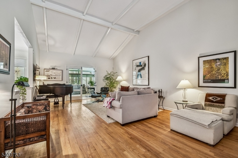 LOCATION!! LOCATION!!  Perfectly nestled on just under an acre in a coveted double cul-de-sac neighborhood, this beautifully maintained CUSTOM raised ranch combines thoughtful design with seamless indoor-outdoor living. A welcoming foyer opens to a sun filled living room featuring vaulted ceilings and a classic wood burning fireplace, creating a warm gathering space. The adjoining newly added sunroom overlooks the wooded backyard and provides access to a spacious deck for all year round living. The main floor centers around a well equipped kitchen with double ovens, a cozy breakfast area and an adjacent formal dining room. The primary suite features a renovated full bathroom and generous closet space. Three additional bedrooms share a full hall bath, and a convenient powder room completes the level. The walkout lower level offers exceptional versatility, featuring a family room and a recreation room with its own wood burning fireplace. This level also includes an additional bonus with a laundry area, a convenient powder room and direct access to the patio and two car attached garage. With excellent curb appeal, flexible living spaces, and a serene setting, this home presents a wonderful opportunity for comfortable everyday living and entertaining alike.