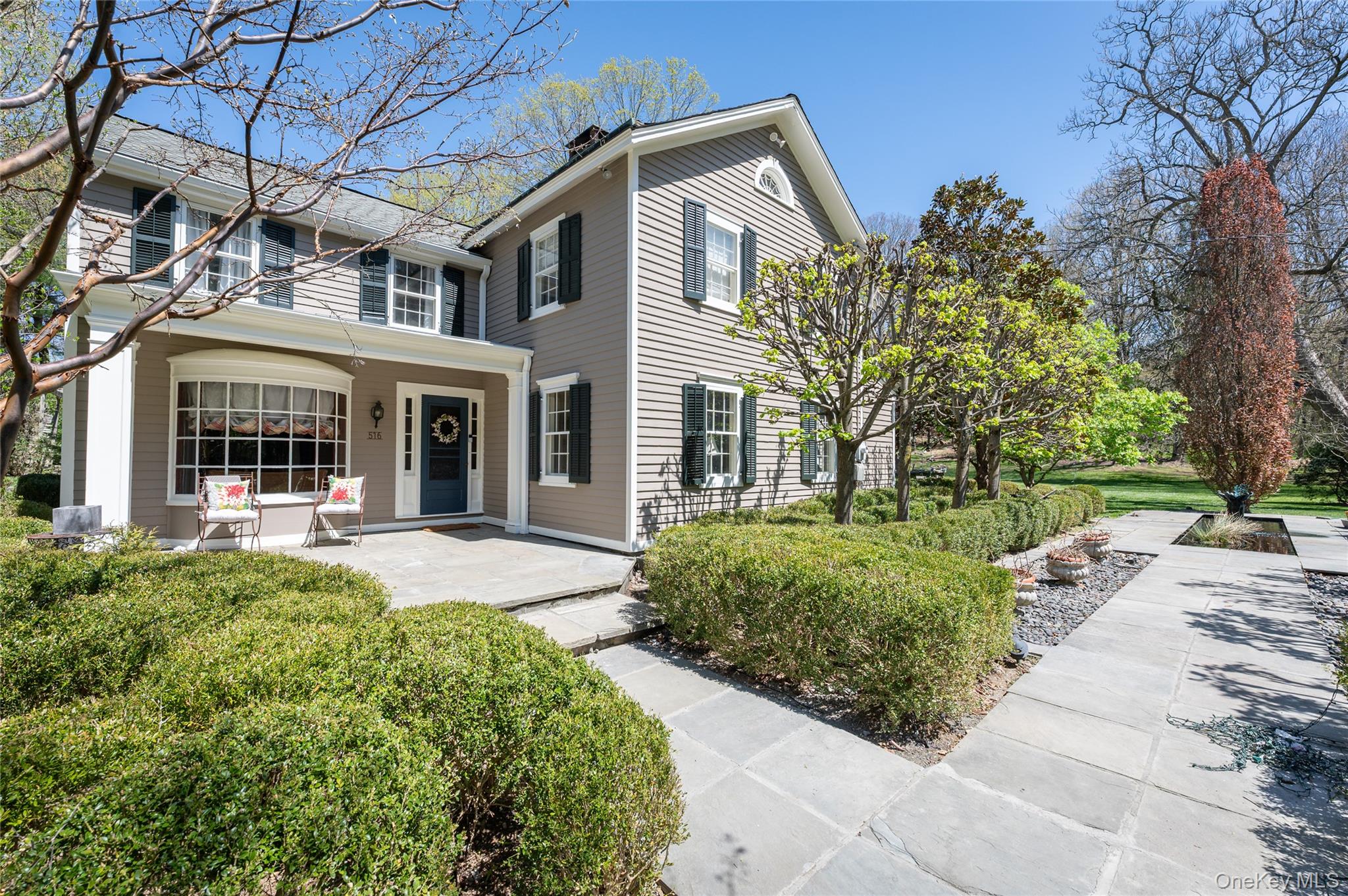 Steeped in history and timeless elegance, this exceptional circa-1800 Hiram Halle Colonial is set on four beautifully landscaped acres. Rich in period character, the home showcases signature Hiram Halle windows, hand-hewn wide-plank antique floors, distinctive pillow ceilings, and multiple wood-burning fireplaces throughout its gracious living spaces. A sun-filled living room, elegant dining room, expansive sunroom, and cherry-paneled library create an atmosphere of warmth and sophistication.The heart of the home is a chef’s kitchen featuring a large center island, custom coffee bar, gas fireplace, and inviting breakfast area with doors opening to the patios and gardens. The second level offers four spacious bedrooms, three full baths, and a dedicated laundry room, blending historic charm with modern convenience.Outside, the estate unfolds into a private retreat with a Gunite pool, mature trees, lush gardens, and exquisite plantings. A classic barn with a fireplace-enhanced upper level offers exceptional flex space with endless possibilities, such as a yoga studio, artist's studio, home office, wellness sanctuary, or gathering space! A rare offering, this remarkable property seamlessly combines historic significance, exceptional craftsmanship, and an extraordinary lifestyle setting.