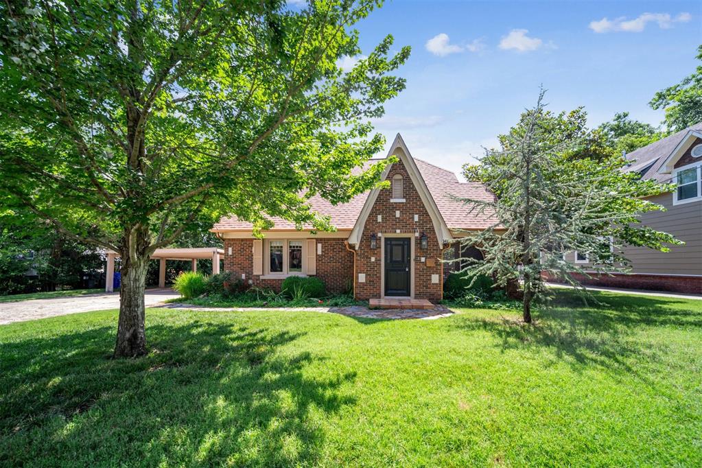 Step into the timeless elegance of this 1930 Tudor-style home, set on nearly 1 acre of unplatted, wooded land in the heart of Norman, just a short walk or bike ride to the University of Oklahoma. The classic Tudor elements like the steep gabled roof, intricate half-timbering, ornate leaded glass windows, and a majestic stone fireplace exude historic charm. Original hardwood floors and richly detailed, handcrafted wood emphasize the homes sturdy yet elegant ambiance and warmth. This rare estate blends the vibrant energy of OU campus life with the tranquil seclusion of your own wooded haven. Live where Tudor craftsmanship meets university spirit.
