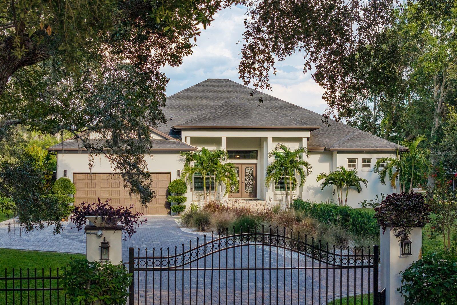 SELLER OFFERING A 2-1 RATE BUYDOWN INCENTIVE!! Resort-style living meets modern construction in this stunning 3-bedroom plus den (optional 4th bedroom), 3-bath gated pool home with water access, built in 2020 using commercial-grade concrete block construction for lasting durability. Located in a non-HOA community with no rental restrictions, this home offers luxury, flexibility, and convenience—perfect as a primary residence, second home, or investment property.Step inside through a custom blown glass front door and experience high ceilings, Turkish marble flooring, and an open-concept layout designed for both daily living and entertaining. A versatile den offers the perfect space for a home office, media room, or can easily be converted into a fourth bedroom to suit your needs. The chef’s kitchen features granite countertops, a brand new refrigerator and dishwasher, a newer oven, range and microwave, a large center island with an added sink, and an oversized walk-in pantry. A custom dry bar with an aquarium viewing feature adds a unique touch of sophistication and fun.The spacious owner’s suite includes two oversized walk-in closets with custom closet systems and a luxurious en-suite bathroom with modern cultured stone finishes and a hidden walk-through his and her shower. The suite also includes custom wall openings for aquarium viewing and remote-controlled privacy blinds, offering a perfect blend of relaxation and elegance.Massive hurricane-impact tri-folding sliding glass doors open to your backyard retreat, where a fully enclosed saltwater pool and screened lanai create a true private oasis. The pool area is equipped with a bamboo plank ceiling, new recessed lighting, new ceiling fans, a 2025 outdoor kitchen, and a perimeter bug spray system. A new pool pump and heater have been installed, offering worry-free enjoyment.  A custom stone privacy wall with built-in fireplaces enhances the ambiance and makes this home ideal for entertaining or enjoying your own peaceful resort-like setting.Additional features include a whole-house audio system, camera system,  whole-home water filtration and softener system, a roof-mounted cell phone booster, internet booster, beautifully redone landscaping, with upgraded lighting. The garage has been upgraded with brand new epoxy floors, custom cabinetry, overhead storage, and a dog wash station—perfect for pet lovers or anyone needing a functional utility space.This waterfront property offers direct water access with no bridges, making it an ideal location to build a dock or enjoy kayaking and paddleboarding right from your backyard. Mangroves were recently maintained, eliminating that task for the new buyer. The home sits on a large lot with excellent frontage, providing both privacy and curb appeal. Conveniently located just minutes from Tampa International Airport, shopping, dining, and local attractions, this home offers a rare opportunity to enjoy the Florida lifestyle in a luxurious and move-in-ready setting.