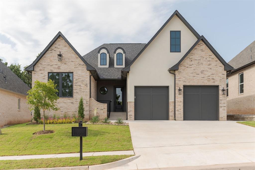 Welcome to a modern French Country home where timeless European influence meets clean, contemporary design in Cross Timbers. From the moment you step inside, architectural details set the tone—graceful arches, curved halls, and timeless finishes that create warmth and character throughout the home. The kitchen balances style and function, with charming green cabinetry anchored by a sculptural stucco vent hood. Nearby you'll find a swinging pantry door that adds both convenience and a touch of nostalgia. The hallway pocket office offers a quiet space for work, planning, or study, tucked neatly into the flow of the home. A powder bath for guests is graced with ornate wallpaper and a stone with a waterfall edge. The primary suite features dual sinks and beautiful brick paver flooring that brings texture and Old World character to the space. Two additional bedrooms and a shared moody blue bathroom complete the home. With classic Tudor elements woven throughout and a layout designed for modern living, this home offers the perfect balance of tradition and comfort.