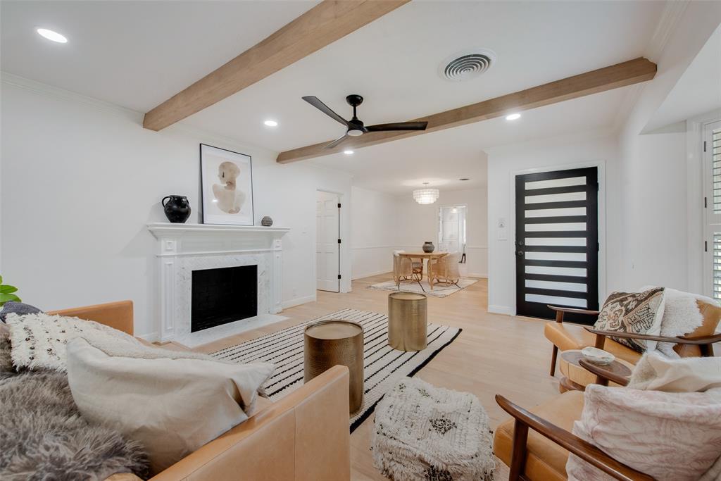 HUGE PRICE IMPROVEMENT! Prepare to be surprised when stepping into this elevated Ridglea North charmer! The property boasts blonde wood flooring throughout. The tasteful  living area has been enhanced with blonde beams, a gorgeous marble tile fireplace with mantle, and wooden shutters. The formal dining room is well lit by a luxurious chandelier and lots of windows. The bright galley kitchen boasts quartz countertops with marble backsplahes, new stainless appliance suite, and upper glass cabinets. There is space for an eat in kitchen experience surrounded by more natural lighting. The mother in law, office, guest room, or bedroom located off of the kitchen has been updated with a soft hued built in desk and wardrobe for more flexibility. The oversized primary suite is well equipped with several closets, and has an enviable ensuite bathroom. Marble from floor to ceiling, this spa bathroom has a double vanity and huge seamless glass door shower. The large utility area has additional storage. The home has a metal fence and remote controlled gate for security. Owner is Broker.