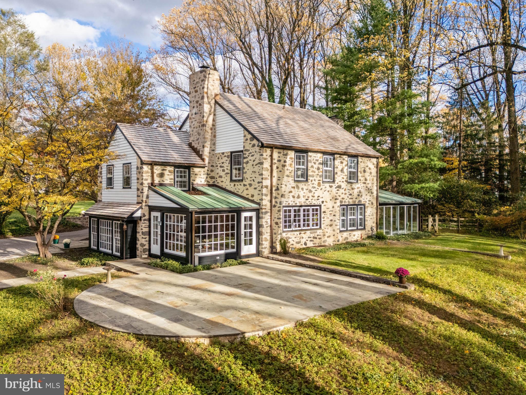 Simply gorgeous pastoral, year-round views greet you when you reside at 188 Abrahams Lane, a truly special property on nearly two acres in Villanova, Radnor Township.  Perfectly perched upon a hilltop overlooking the storied and historically significant Ardrossan Farm, this renovated Farmhouse home and extensive property provides a rare offering for the most discriminating buyer.  This property is in one of the most coveted settings on the Main Line framed by extraordinary and protected farmland.  The current owner thoughtfully renovated this home to the highest standards with attention to detail at every opportunity.  The elegant and warm interior matches the extraordinary exterior design of the structure and grounds featuring perfectly designed stone hardscaping and natural landscapes, including award-winning daylilies curated by the original owner.  The entry to this Historic Farmhouse features stately double doors, rich cherry paneling surrounding a woodburning fireplace.  The Main Level provides unique blue stone slate floors in the entry way leading to all living areas; the living room features a fireplace with surround cabinetry, deep set windows, oak floors, and an abundance of light;  French doors open to the sun room overlooking the expansive hillside to the Ardrossan Estate valley with magnificent barn views providing year-round living space with custom, insulated laminated glass walls providing noise and UV protection; a convenient wet bar located between the living and dining room perfect for entertaining;  the dining room, just off the foyer, also overlooks the farm meadow through large windows; the kitchen provides a cook’s desired workspace with historic barn and sunset view; a corner exposure with sundrenched breakfast area completes the kitchen and offers another convenient entrance  just steps to the patio and pool;  a welcoming family room with stunning Farmhouse fireplace with original stone and reclaimed wood mantel, a wood beamed ceiling, and cherry floors complete the Main Level.  A perfectly designed central staircase leads to the Second Level featuring five light-filled bedrooms with beautiful corner exposures. The primary suite runs front-to-back with breathtaking views of the Ardrossan Farm meadow, a full bath w/double vanity, walk-in closet, recessed windows with original tile sills and detailed millwork; the two additional hall bedrooms enjoy Jack & Jill full bath; the fourth bedroom is a full suite w/hallway, an abundance of windows, two closets and full bath; the fifth bedroom, a separate wing, is accessed from additional back staircase allowing for perfect guest accommodations or au pair suite,  w/laundry and a full hall bath to service all bedrooms, if necessary.  The Third Level is unfinished with expansive space easily designed for additional bedroom suite.  The detached two-bay garage features stone and elegant architectural lines and details that complement the house.  It features exposed stone interior walls, cherry wood ceiling, and recessed lighting.  The finished second floor also has a cherry wood ceiling and recessed lighting, providing a lovely space for home office or studio.The expansive private grounds provide features to satisfy an active family.  An in-ground pool with sunset backdrop, a large flat, fenced back yard, and sizable dog run area discretely located on the side of the property.  Curved stone walls surround a circular arrival court framing the main entry, and historic streetlamps provide elegant property lighting. All discriminating buyers will appreciate the architectural details throughout the home, including solid cherry doors, extensive millwork throughout, brass hardware, sophisticated lighting design, Duratherm windows and other subtleties creating a warm and luxurious living environment.  This exquisite home/property is nestled among bucolic farmlands just minutes to conveniences- Chanticleer, top-rated schools, shopping, dining, transportation, I-476!