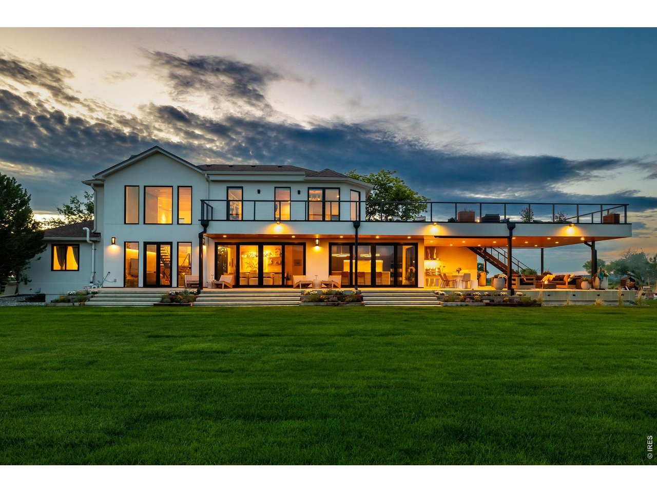 SURROUNDED BY OPEN SPACE. DEFINED BY THE VIEW. Completely reimagined and surrounded by protected open space, 6915 Goose Point offers something increasingly difficult to find in Boulder County: the experience of avast private landscape without the responsibility of maintaining one. Own a manageable 1.6 acres while adjoining conservation easements and protected open space make the property feel and live like dramatically more. Sweeping views stretch across the Flatirons, Longs Peak and the Front Range, while a quiet half-mile approach creates remarkable privacy and a true sense of arrival-all less than 15 minutes from downtown Boulder. Reimagined by Steve Dodd Architecture, the 5,688-square-foot residence balances sophisticated organic-moderndesign with warmth and livability. Soaring ceilings, walls of glass, hemlock-paneled ceilings, wide-plank white oak floors, natural stone and designer lighting frame the landscape throughout. At the heart of the home, a chef's kitchen pairs Wedgewood walnut cabinetry with an oversized waterfall island and premium appliances. Expansive glass doors blur the boundary between indoors and out. Upstairs, the private primary retreat opens directly to the expansive view deck and features a custom walk-in closet and spa-inspired bath. Outside, a fully equippedkitchen, covered dining and lounge areas, fire features, extensive landscaping and an approximately 1,000-square foot upper deck create resort-like outdoor living designed around the views. A completely reimagined modern home where you maintain 1.6 acres-but experience a landscape that feels exponentially larger.