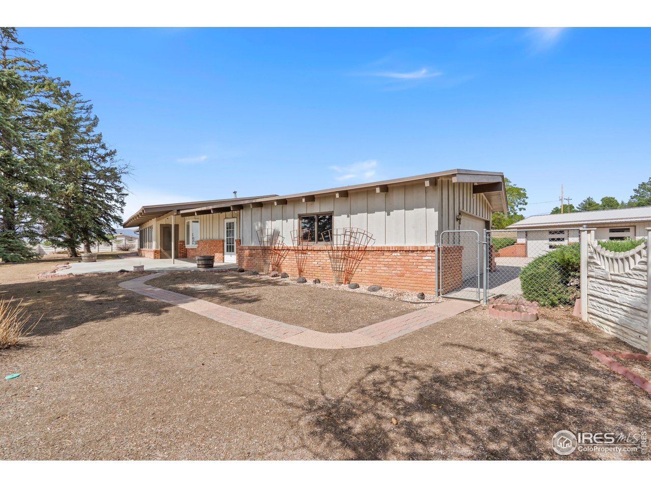 Discover this rare property with a perfect blend of space, location and opportunity. This unique and well-built ranch-style home sits on 4.5 prime acres and is ready for your personal touches and updates.....4+ Car Garages; Plenty of room for vehicles, storage, or a workshop; Flat; usable acreage with endless possibilities for expansion, gardening, or hobby farming; Mountain Views - Start and end your day with stunning views of the Front Range. With 4.5 acres, you'll have room to expand, garden, or simply enjoy wide-open spaces; Peaceful Setting - Surrounded by lakes, wildlife, and fresh air, yet just minutes from downtown, dining, shopping and entertainment; Endless Potential - A solid mid-century home with character and charm, ready for updates that fit your style; Subdivide for future income opportunities.Whether you're dreaming of modern renovations, creating a private retreat, or simply enjoying open space with mountain views, this property has it all.