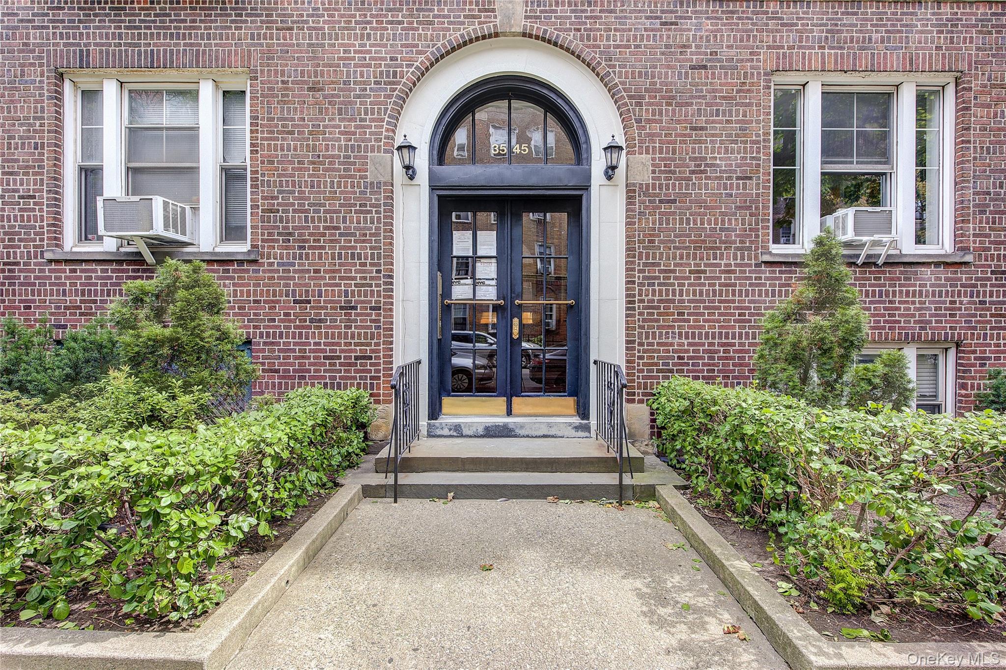 Garden views and classic prewar details define this spacious two-bedroom, one-bathroom home at Hampton Court, a historic garden cooperative in Jackson Heights.The home features 9-foot cove ceilings, hardwood floors, original millwork, and eastern and western exposures. East-facing windows overlook the cooperative’s interior garden, while west-facing windows bring in afternoon light. An entry foyer with two closets leads to a generously sized living room and separate formal dining room.The windowed kitchen has walnut cabinetry with glass-front cabinets, granite countertops, stainless-steel appliances, and a custom-built microwave cabinet. A rolling butcher-block island adds workspace and storage. Both bedrooms have large windows and deep closets. The renovated windowed bathroom features a modern tile surround, glass shower doors, and a vanity with storage.Building amenities include a live-in superintendent, common laundry, and a complimentary basement storage bin assigned to the unit. The co-op requires 25% down and has no flip tax. Monthly maintenance is $831.60, plus a $230.30 monthly assessment and an additional $831.60 charge designated for future capital repairs. Cats are permitted; subletting is not.Hampton Court comprises 11 Neo-Georgian buildings surrounding a private interior garden. Located in the Jackson Heights Historic District, it is one block from Travers Park and 34th Avenue Open Streets, with the Sunday farmers’ market nearby. The 74th Street–Roosevelt Avenue transit hub offers multiple local and express subway lines.