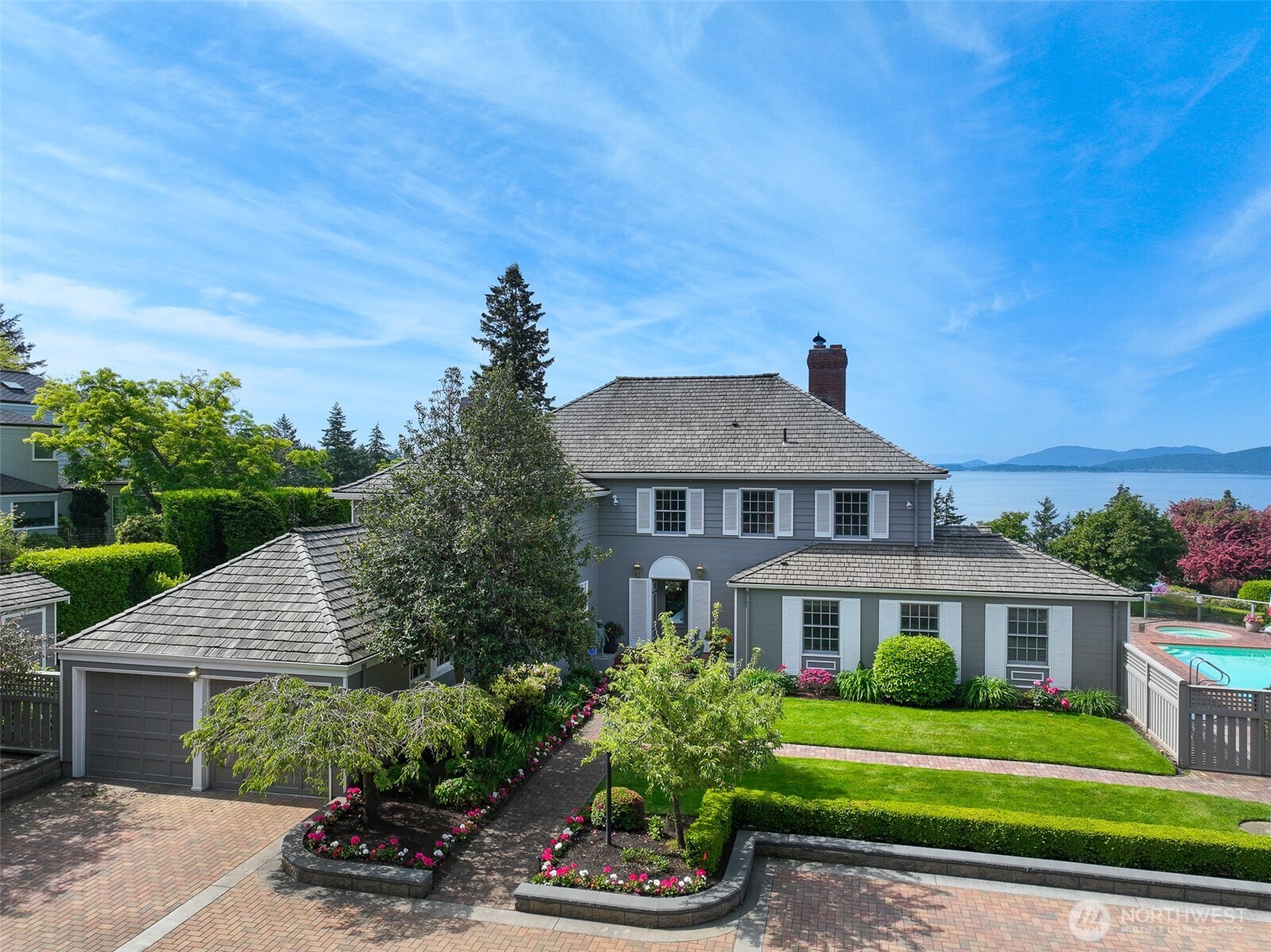 Circa 1939 historic Edgemoor mansion capturing the character, craftsmanship and presence of Old Edgemoor, set along one of the neighborhood’s original view streets. Timeless details include beautiful built-ins, crown molding and generous formal and casual living spaces. The residence offers 5 bedrooms and 5 baths, including historic service quarters with a separate staircase, bedroom, bath and sitting area—ideal for guests, extended living or a private retreat. Sweeping views of Bellingham Bay, the San Juan Islands and Salish Sea create an unforgettable marine backdrop. Resort-style grounds feature a swimming pool, hot tub, attached 2-car garage, detached 2-car garage and an extraordinary covered copper-roof rotunda/gazebo. A rare opportunity to enjoy Old Edgemoor charm, commanding views and estate-style living in one of Bellingham’s most treasured neighborhoods. An adjacent fully serviced 1+ acre building lot with water, sewer, power and natural gas may also be available.