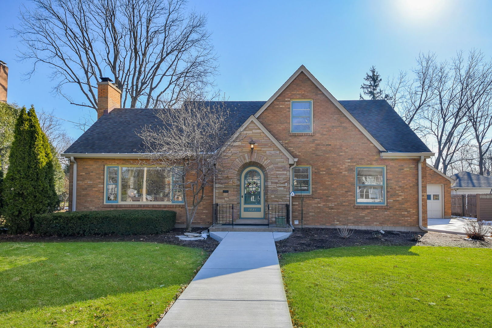 Welcome to 1031 North Spring Street in Elgin, a classic cottage-style home set on a beautiful double lot with outstanding curb appeal. This charming all-brick home is truly in move-in condition, offering timeless character, spacious living areas, and numerous recent improvements.    Step inside to a cozy living room, with hardwood flooring under the carpet, featuring a large picture window that fills the space with natural light and a beautiful stone fireplace that creates a warm focal point. The spacious kitchen offers abundant cabinetry, Corian countertops, new appliances, and a large new picture window. Within the kitchen area is a bright dinette space, highlighted by another picture window overlooking the stone patio and expansive backyard, making it a wonderful spot for everyday dining.    The main level includes two bedrooms and a recently remodeled full bathroom. A bright sunroom adds even more charm with exposed brick, tongue-and-groove knotty pine walls, and sliding glass doors leading to the stone patio, creating the perfect place to relax or entertain while enjoying views of the yard.    Upstairs you will find two very large bedrooms connected by a convenient Jack-and-Jill bathroom, offering comfortable space and privacy for family or guests.    The finished basement provides additional living space with a recreation room, a flex room that could serve as another bedroom or home office, a full bathroom, and abundant storage, including built-in cabinets, a separate storage room, and a large, light-filled laundry room.    Outside, the backyard is truly exceptional, offering plenty of room to relax, entertain, garden, or for kids to play. The stone patio creates a wonderful outdoor gathering area within the expansive yard. The property also features an oversized all-brick detached garage, providing excellent storage and parking.    This home has been thoughtfully maintained and extensively improved with numerous updates, including:    2025: New concrete driveway, walkways, and stoops; two picture windows replaced; all windows serviced with new handles, clasps, and locks; backyard clothesline installed; new Bosch dishwasher installed; garage door facing replaced; trees removed and landscaping improved; interior doors sanded and made operational; two pocket doors restored and made operational; new custom window shades from Budget Blinds; kitchen repainted; gas fireplace cleaned and serviced; front porch railing restored and painted.    2024: New furnace, ducting, and humidifier; new gutters, downspouts, and leaf filter system; electrical updates inside and outside, including exterior spotlight; radon mitigation system installed; ADT security system installed; new LED lighting and ceiling fans installed, fluorescent lighting replaced, and dimmers and GFI outlets added inside and outside; plumbing repairs including laundry faucet, main bathroom faucet, and handheld shower sprayers; new smoke and CO2 detectors installed; dryer vent professionally cleaned.    Ideally located just minutes from the Metra train station, downtown Elgin restaurants, the community recreation center with indoor pool, the Hemmens Cultural Center theatre, parks, shopping, and entertainment, with easy access to I-90 for convenient commuting.    A rare opportunity to own a charming cottage home on a beautiful double lot with extensive updates, classic character, and an outstanding location.