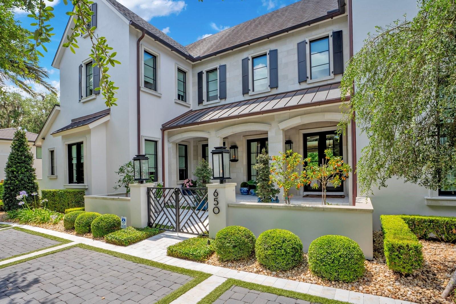 Under contract-accepting backup offers. Introducing one of Winter Park's most extraordinary offerings — a meticulously designed transitional masterpiece by the acclaimed Winter Park Custom Homes, set on a rare 0.34-acre corner lot in one of the city's most coveted neighborhoods. From the moment you arrive at the circular front drive and step onto the marble-tiled covered front porch, it's clear this home is in a class of its own. Inside, soaring beamed ceilings and wide-plank engineered wood floors set an elevated tone throughout. The grand living room features a gas fireplace and dramatic accordion glass doors that dissolve the boundary between indoors and out, opening to the resort-style backyard with ease. The chef's kitchen is a true work of art: anchored by a massive island with wraparound seating, Thermador gas range and oven, built-in refrigerator and microwave, marble countertops, and a generous walk-in pantry — all complemented by stunning herringbone hardwood floors that make this space feel straight out of the pages of a design magazine. A butler's hallway and charming brick-floored cozy reading room add warmth and character to the everyday. Also on the main level, a full en-suite office — easily serving as a 6th bedroom — offers flexible living for guests or multi-generational needs, while a separate powder room is thoughtfully reserved for guest use. The primary suite is a sanctuary unto itself: a private vestibule entry leads to a spacious bedroom retreat with accordion-style doors that open directly to stepping stones leading into your personal spa. The spa-inspired primary bath showcases marble countertops and inlay floors, separate sink vanities, a freestanding soaking tub, a walk-in shower, and a custom-built walk-in closet that rivals any boutique. Upstairs, four generously sized en-suite bedrooms — each with walk-in closets — surround a spectacular bonus room complete with a wet bar, perfect for entertaining or movie nights. The third floor is a true Winter Park rarity — an expansive additional living level with a dedicated gym area and playroom ideal for home theater, creative pursuits, or whatever your lifestyle demands. Built-in speakers complete the experience. Step outside to your own private resort. A heated pool and spa with a sun shelf, fire bowl, and serene stepping stones are framed by lush artificial turf and elegant marble-inlaid pavers. The covered back patio with tongue-and-groove ceiling and fireplace creates an al fresco living room, while the outdoor grill with prep sink makes entertaining effortless. Natural gas throughout, a full-house generator, sauna, and an epoxy-floored two-car side garage round out this exceptional property — all seamlessly controlled through a whole-home Control4 automation system that puts lighting, climate, audio, security, and more at your fingertips. Zoned for A-rated Winter Park schools and just minutes from Park Maitland School (K–6), Park Avenue's world-class dining and boutiques, and all that Central Florida has to offer. Homes of this caliber, at this scale, in this location simply do not come available often. This is not just a home — it's a lifestyle.