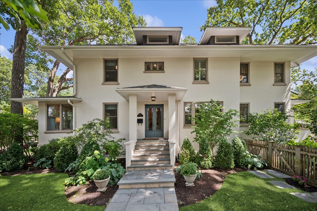 Come tour this stunning, classic Wilmette home featuring 2019 whole house renovation - idyllically located on brick-paved Maple Avenue in sought-after McKenzie School District! The perfect blend of original charm with all of today's updates, this home has 5 bedrooms, 3 full and 2 half bathrooms. Gracious entry as you walk through the double set of French doors, opens to huge living room and sunroom with tons of pretty windows and gas fireplace. Charming formal dining room features original ceiling beams. Beautiful chef's kitchen with custom cabinetry, honed marble countertops, Waterworks tile backsplash, top of the line appliances: Wolf range & double ovens, Miele dishwasher, and SubZero refrigerator; breakfast bar, walk-in pantry and eat-in table space! Mudroom with entry from the backyard, and two powder rooms round out this first floor. Upstairs is the primary suite with lovely bathroom: double sink vanity, soaking tub, separate shower and water closet; walk-in closet also features the 2nd laundry. Two additional family bedrooms share the dual vanity hall bath. The third floor features a fourth bedroom as well as a tucked away office space. The finished basement has a dug-out recreation room, full laundry room, and features the fifth bedroom with full bath which is wonderful for guests or a live-in nanny. This sunny corner lot also features a south-facing fully fenced yard with bluestone patio and covered porch, attractive landscaping installed & maintained by Chalet! The 1.5 car garage is off the alley, with a concrete paved parking pad on the side. List of all improvements from their renovation is attached. Walk to all downtown-Wilmette has to offer and the train!