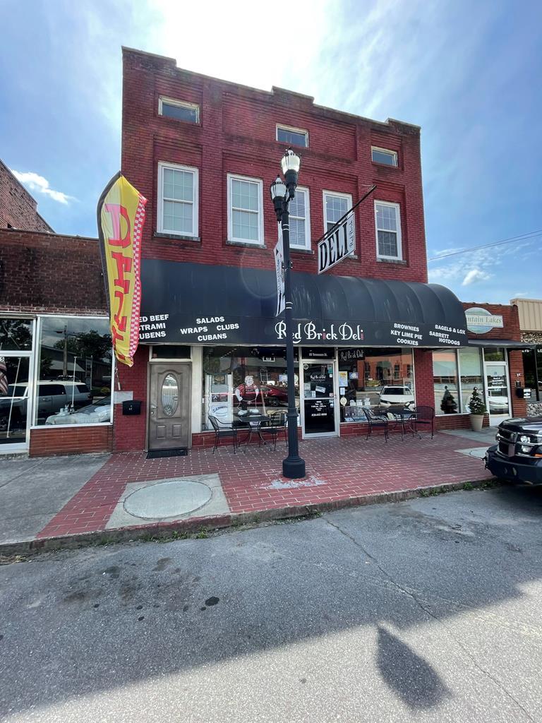 Discover the chance to own one of Western North Carolina's most beloved Delis, situated in the heart of downtown Murphy. This turn-key, well-established lunchtime hotspot is a local favorite and a magnet for tourists, boasting a loyal customer base and a prime location within walking distance of thriving businesses. Fully operational and profitable, this opportunity comes complete with a first-class, loft-style apartment featuring 10-foot ceilings, hardwood flooring, large windows, granite surfaces, custom cabinetry, and a blend of timeless architectural charm and contemporary finishes. The executive apartment offers two bedrooms, two baths, an office/bonus room, and a grand private entrance—perfect for luxurious living or as a lucrative rental for additional income. Don't miss this rare blend of business success and upscale living in vibrant Murphy!