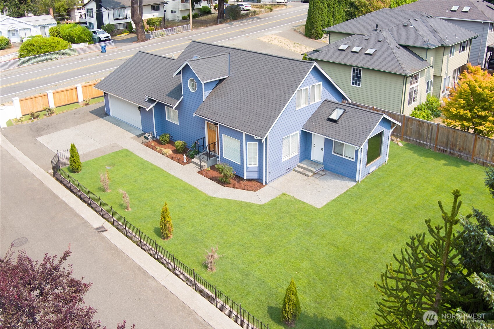 Set in a highly desirable Westgate location just minutes from Edmonds, this beautifully updated 2 story home offers both convenience and style with easy access to major thoroughfares. The thoughtfully designed kitchen features a spacious island with seating, abundant storage, and opens seamlessly to the dining area complete with a cozy fireplace—perfect for entertaining. Expansive windows throughout invite natural light and create a seamless connection to the outdoors. Just off the kitchen, the inviting family room provides direct access to a private, fully fenced backyard with a patio.  The main level also includes a full-bath, laundry area, and access to the oversized two-car garage. Upstairs there are 2 additional large bedrooms offering a perfect space to relax. The primary suite serves as a luxurious retreat, featuring an oversized walk-in shower. The lower level includes another huge additional bedroom, a full bath, and a flexible adjoining space well-suited for a study area, playroom, or creative nook. Located minutes from Westgate Elementary, and with easy access to downtown Edmonds’ dining, shopping, galleries, beaches, train station, and the Edmonds ferry, this home truly combines comfort, functionality, and an exceptional location.