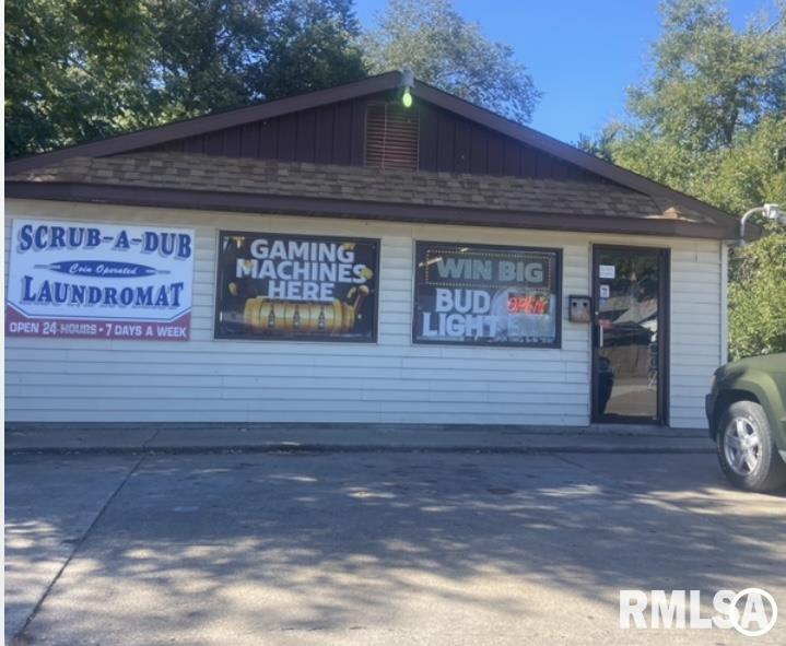 Exceptional opportunity to own a versatile commercial property offering nearly 2,500 square feet all on one level in a high-traffic location surrounded by established businesses. This unique property combines income potential, business opportunity, and flexible use options all under one roof. The front portion of the building features approximately 1,800 square feet previously operating as a fully equipped self-service laundromat. All equipment conveys with the sale, including commercial washers and dryers, change machines, 3-well sinks, vending machines, tables, and chairs—making this a true turnkey business opportunity. At the rear of the building, you’ll find a brand-new, fully furnished 2-bedroom apartment currently generating $1,500 per month as a short-term rental. The apartment includes a new water heater installed in 2026, and the furnace is approximately 6–7 years old. Live on-site while operating your business, continue the current laundromat setup, or bring your vision and transform the space into something entirely new. With its flexible layout, established location, and endless possibilities, this property is ideal for entrepreneurs, investors, or anyone seeking a live/work opportunity. The sky is truly the limit with this one-of-a-kind commercial property!