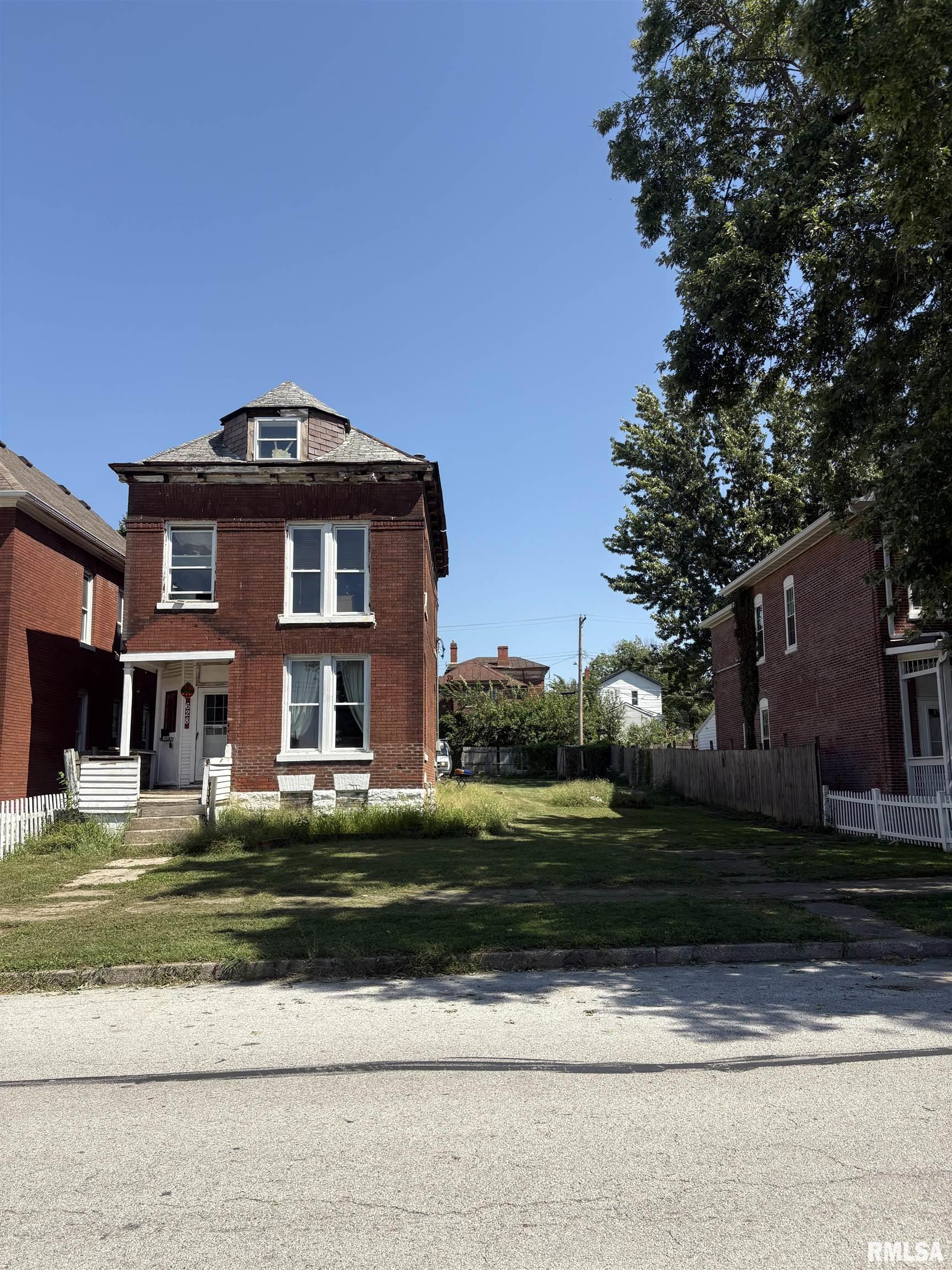 Investment Opportunity! Bring your vision and some TLC to this three-story brick home located at 628 North 7th Street in Quincy. Featuring 3 bedrooms and 2 bathrooms, this property offers plenty of space and character, making it a great opportunity for an investor, renovator, or landlord.  The home also features upper-level laundry conveniently located near the bedrooms, adding an extra level of convenience to the floor plan.  The sale includes two separate parcels, offering additional land and flexibility. The second parcel is the vacant lot directly south of the home, which was formerly addressed as 624 North 7th Street.  The home has most recently been used as a rental and does need work. Property is being sold AS IS, with inspections welcome for the buyer's information. Whether you're looking to restore the existing home, add value through improvements, or take advantage of the additional lot, this property offers plenty of potential.