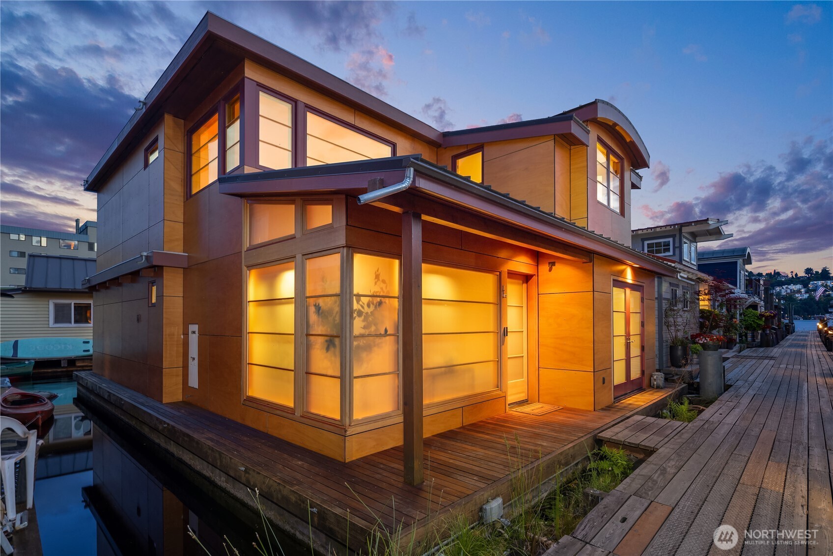Custom-built Japanese-inspired NW Contemporary floating home juts into its sunny south-side slip—a rare placement offering unobstructed channel views of Lake Union. Corner living room glass sliders fuse interior space with the water’s edge for seamless indoor-outdoor living. Expansive 3-level floorplan features 3 proper bedrooms, a concrete float with a full-height finished basement, CVG fir cabinetry & trim, exposed beam ceilings & exterior clad in PRODEMA® siding. Modern comforts like Fiber internet, heat-pump heating/cooling & natural-gas tankless water heater. Located on Eastlake in the well-run 'Tenas Chuck' co-op. No-stairs dock with upgraded infrastructure incl. new steel pilings, plus a tucked-away city parking lot with 4 chargers.