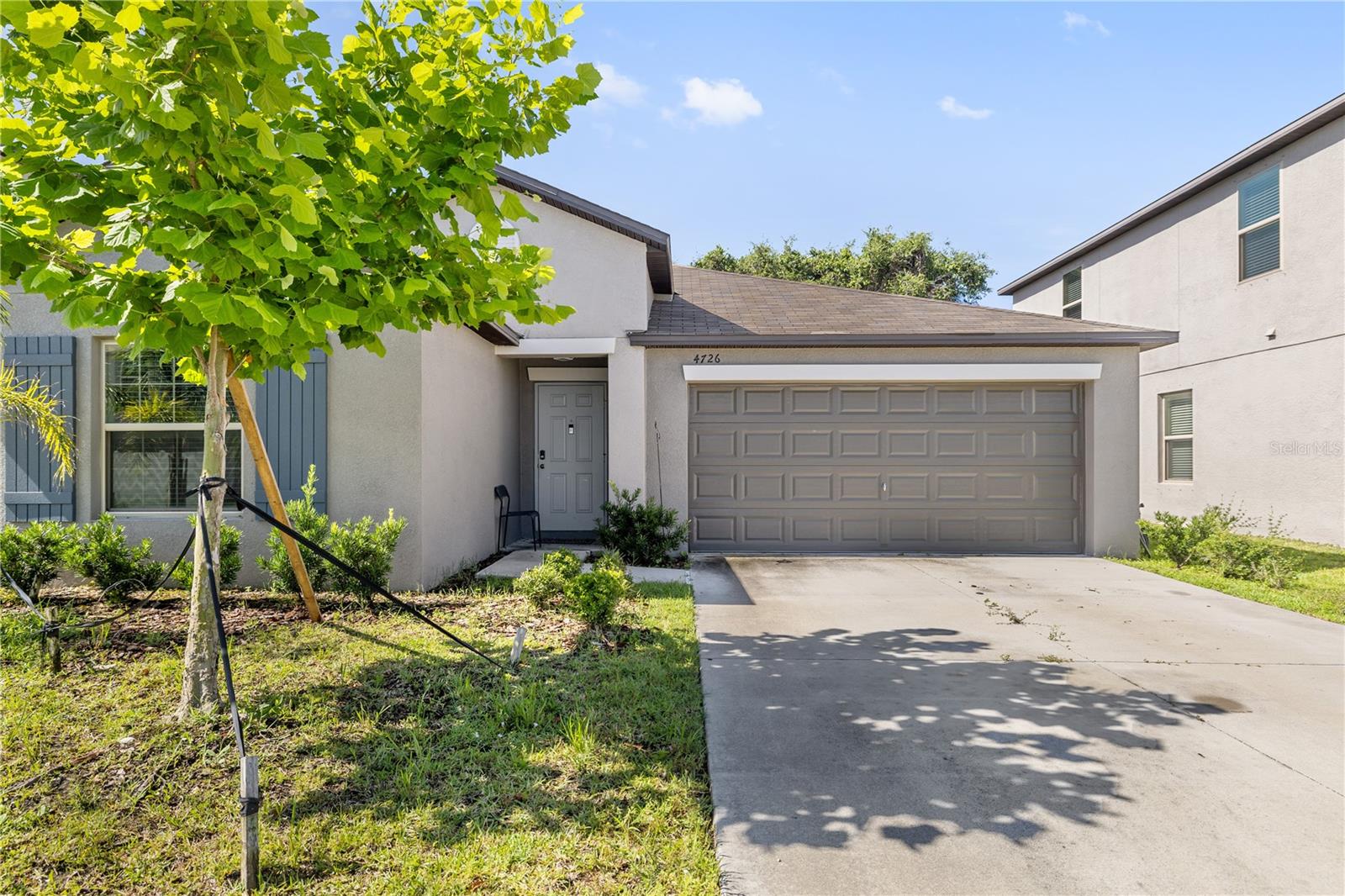 This beautiful and well maintained one-story residence, situated in Tampa’s Touchstone community, offers higher degree of privacy, quiet neighborhood and ready for immediate occupancy. The backyard has outstanding presents view, ideal for appreciating the stunning sunrises that grace the area. Constructed by Lennar in 2021, this meticulously cared-for property exemplifies the nearly new condition of the HARTFORD model. This floor plan featuring three guest bedrooms and a full bathroom, with the primary suite conveniently located at the rear of the home. The spacious primary bedroom serves as a serene retreat, providing ample space for relaxation. The Master Suite bathroom is equipped with a shower, double vanity, water closet, linen closet, and an impressive oversized walk-in closet . The three additional bedrooms, each featuring built-in closet systems, along with a guest bathroom that includes a tub/shower combination and a floor-to-ceiling linen closet, ensure ample accommodation for family and guests. The heart of this home is the open-concept living area, which boasts a large great room that seamlessly connects to the dining area and a well-equipped kitchen. The modern kitchen, designed for the culinary enthusiast, features a spacious island with a breakfast bar, Stainless Steele appliances, and including 36-inch staggered cabinets and roomy walk-in pantry, this kitchen is perfectly setup for cooking enthusiast. Natural light floods every corner of the home, while the volume ceilings and neutral color scheme provide an excellent canvas for personal decor. Each room is fitted with upgraded ceiling fans. The beautiful backyard perfect for hosting gatherings or enjoying quiet evenings under the stars. The two-car garage adds to the convenience of this remarkable property. Shopping and Dining Close to Brandon Town Center, you’ll find a variety of shopping, dining, and entertainment options just a short drive away. From retail therapy to gourmet meals, everything you need is within reach. Easy Commute With convenient access to major highways like I-4 and I-75, commuting to downtown Tampa, Brandon, and other surrounding areas is a breeze. This prime location ensures you’re never far from the heart of Tampa. Don’t miss the opportunity to make your new home. Schedule a viewing today and experience the comfort and convenience in beautiful!