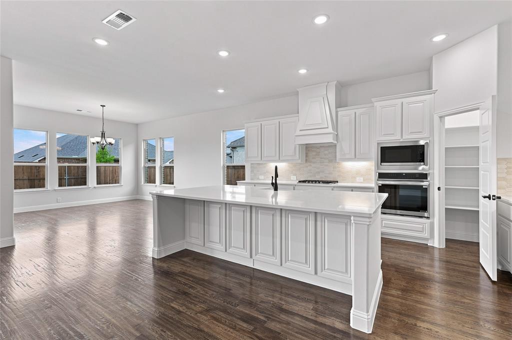 WELCOME TO RIVER RANCH IN VAN ALSTYNE! Discover the popular KEYSTONE by STONEHOLLOW HOMES, a spacious, light-filled floor plan designed for comfortable everyday living. Generously sized rooms and abundant windows create an open, inviting feel, while the oversized family room offers plenty of space to gather and entertain. The gourmet kitchen features extensive cabinetry, a large island, built-in gas cooktop, designer wood vent hood vented to the exterior, and built-in oven and microwave. Nail-down hand-scraped wood floors add warmth and character throughout the main living areas. The primary suite includes two separate closets, two vanity areas, and a spa-inspired Super Shower. A mud cabinet near the garage entry adds convenient everyday storage. 1430 Colorado Rd combines thoughtful design, beautiful finishes, generous living spaces, and abundant natural light to create a home that feels open, comfortable, and ready to enjoy.
