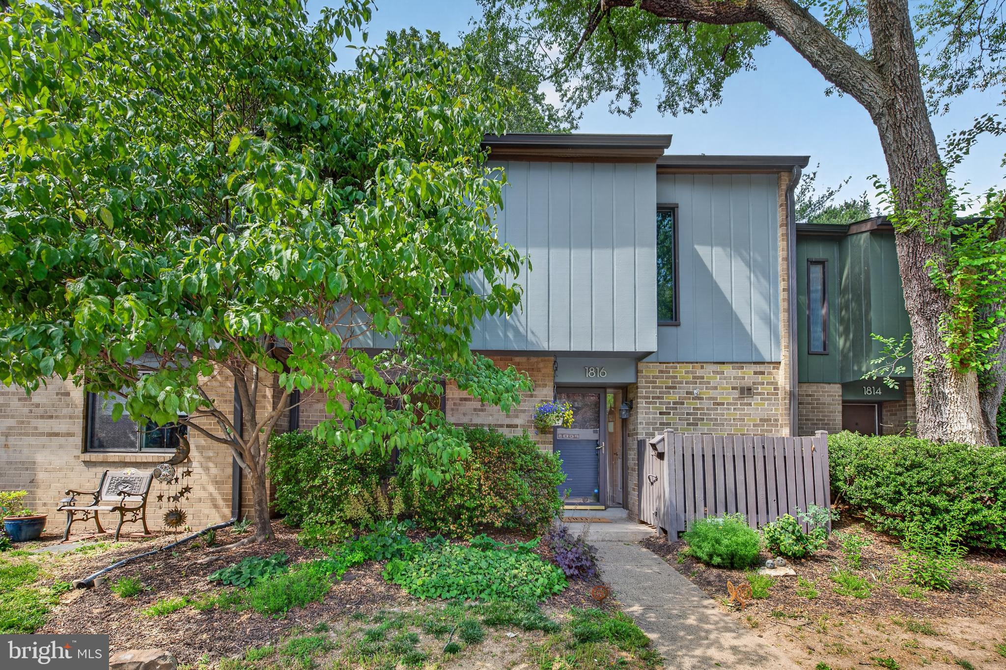 Nestled in a fantastic Reston location within Ivy Oak Square Cluster, this beautifully updated Mid Century Modern townhome offers stylish living with exceptional access to everything the area has to offer. Walkable to the 45-mile-long W&OD Trail, Reston Town Center, two Metro stations, shopping, dining, parks, and Reston’s extensive network of trails, outdoor pools, tennis courts, and community amenities, the location is hard to beat.Inside, the main level features hardwood floors and a thoughtfully redesigned layout centered around the expanded kitchen — a renovation unlike most other units in the community. Walls were removed to completely open the space, creating a much larger and more functional kitchen that flows seamlessly into the breakfast area and family room. Updated with new cabinetry, countertops, and appliances, the kitchen offers abundant prep space, storage, and a bright, open feel throughout the main living area. A private home office, laundry area, convenient powder room, and extra storage area under the stairs complete the main level.Step outside to the expansive stamped concrete patio and fully fenced backyard overlooking the community park and playground— a wonderful setting for relaxing, dining outdoors, or gathering with friends and neighbors. The patio is complete with Virginia native pollinator plants and features a water spigot and exterior outlets, perfect for gardeners.Upstairs, you’ll find three generously sized bedrooms, including a spacious owner’s suite with an ensuite bath featuring an enlarged shower and walk-in closet. The two additional bedrooms share the fully renovated hall bath, completed in 2024 with new tile flooring, a new tub with tiled surround, upgraded fixtures, and quartz countertops. The upper level also offers a large additional storage closet in the hallway, along with pull-down attic access, uncommon in other units, for even more storage.Additional updates include solid core doors (2016), washer and dryer (2017), stamped concrete patio (2018), furnace, A/C, humidifier, and UV light system (2018), water heater (2020), kitchen appliances (2020), refrigerator (2025), kitchen cabinets and countertops (2022), and the majority freshly painted in 2024 and 2026. Gas heat, water, landscaping (tree/shrub pruning and lawn care), trash removal, snow removal, exterior maintenance (including roof, masonry, windows, and doors), and pest control are included in the condo fee, adding comfort and value year-round.Reston’s founder, Robert E. Simon, hired local architectural design firm Collins & Kronstadt in 1970 to plan the community. As part of one of Reston’s early neighborhoods, this townhome reflects Mid Century Modern design principles through its low-pitched roof, vertical wood siding, buff-beige cladding, expansive window openings, projecting second-story overhangs, and large rear sliding glass doors that emphasize the relationship between interior living spaces and the surrounding natural landscape.Enjoy the perfect combination of updated living spaces, outdoor enjoyment, and an unbeatable Reston location convenient to major commuting routes and all that Northern Virginia has to offer.
