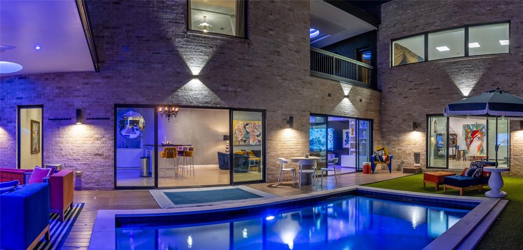 Custom-designed and built by A.GRUPPO Architects for its current owner, 2010 McMillan is a distinctive architectural residence in Dallas’s coveted M-Streets area, blending gallery-inspired interiors, resort-style outdoor living, and exceptional entertaining spaces. Ideally situated between Lower Greenville and the anticipated 2027 transformation of Upper Henderson Avenue, this one-of-a-kind home offers a sophisticated take on modern East Dallas living.Smooth white walls, clean architectural lines, integrated art-hanging rails, and a customizable Control4 lighting system create the atmosphere of a private art gallery. The home’s signature C-shaped floor plan surrounds a resort-style pool courtyard, complemented by an outdoor kitchen featuring Aspire by Hestan cabinetry, gas grill, refrigerator, and double burner.4 distinct living areas provide remarkable versatility. The front living room flows into the kitchen and dining area, with a cozy study nearby. The chef’s kitchen features an expansive island, abundant cabinetry, Bosch refrigeration and dishwasher appliances, and a Thermador Professional Series gas range and oven. A spacious bar and great room anchor the home’s entertaining spaces, while a dramatic two-story studio at the rear offers endless possibilities for creative pursuits, work, fitness, or large gatherings.Upstairs, the generous primary suite opens to a private covered balcony with a fireplace and beautiful views overlooking the pool. The primary bath features dramatic vaulted ceilings and luxurious appointments. Two additional bedrooms share a Jack-and-Jill bath, while the studio’s loft-style bedroom, affectionately known as the “Moroccan Room,” adds a unique touch.Architecturally striking and thoughtfully designed, a rare opportunity to experience artful living, exceptional flexibility, and effortless entertaining.