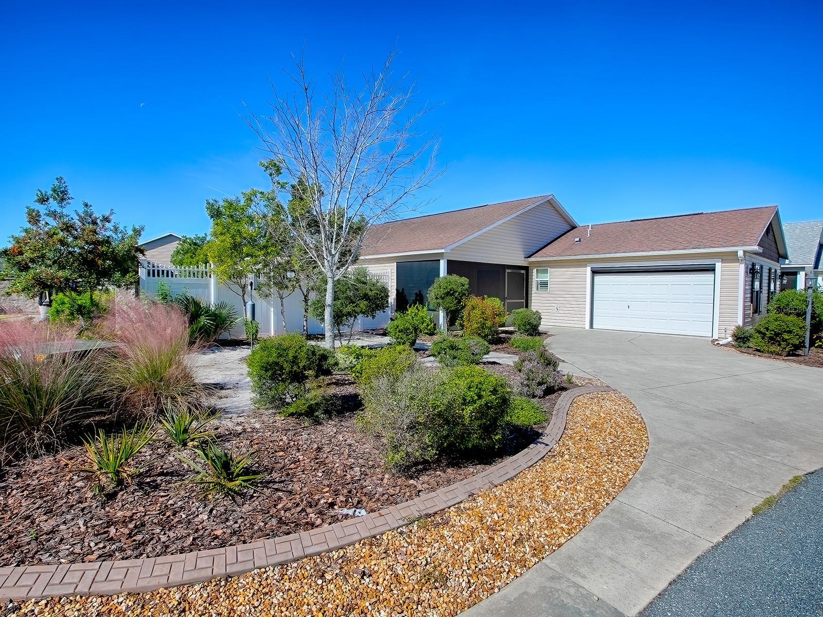 Beautifully Designed & Updated Anna Maria Courtyard Villa in the Village of Dunedin!  From the moment you arrive, you will be impressed!  Located on a Premium Corner Lot with Low Maintenance Floridian Landscaping, PRIVACY & Expansive Outdoor Space. There is room for a small pool OR Golf Cart Garage, if desired.  This STUNNING 3-bedroom, 2-bathroom home offers approx. 1,600 square feet of beautifully designed living space, plus a GLASS ENCLOSED LANAI, perfect for entertaining or relaxing in privacy.  The Main Living Area, Primary Bedroom, & Enclosed Lanai feature Wood-Look TILE Flooring.  The Light & Bright OPEN CONCEPT FLOOR PLAN offers Volume Ceilings, Plantation Shutters & Crown Molding.  The REMODELED KITCHEN is a Dream with Updated Soft-Close Cabinetry & Stylish Hardware, GRANITE Counters, Timeless Complementary Backsplash, Center Island and updated Stainless Steel Appliances!  The Large Primary Ensuite accommodates your King-sized furniture, has Granite Counters and a Walk in Shower.  The Secondary Bedrooms are located in the front of the home away from the Primary Suite, both have closets and cozy carpet.  The Guest Bath has Granite topped Vanity and tub/shower combo. Additional highlights include: **NEW ROOF SCHEDULED** Brand New Washer/Dryer, Screened-in Oversized Front Porch, Powered Screen Garage Door, Pull Down Attic Ladder, a Termite Bond.  HVAC 2014 with new capacitor, HWH 2020.  Whether you're relaxing inside or enjoying the expansive outdoor area, this home offers the perfect setting for Florida living at its finest.  The Village of Dunedin is nestled between Brownwood Paddock Square and Lake Sumter Landing. Whether it's golf, recreation, shopping or dining that you desire, it's all available! You'll enjoy quick access to either Buena Vista or Morse Boulevard too, for those days that your adventures take you beyond all the amenities you already enjoy!