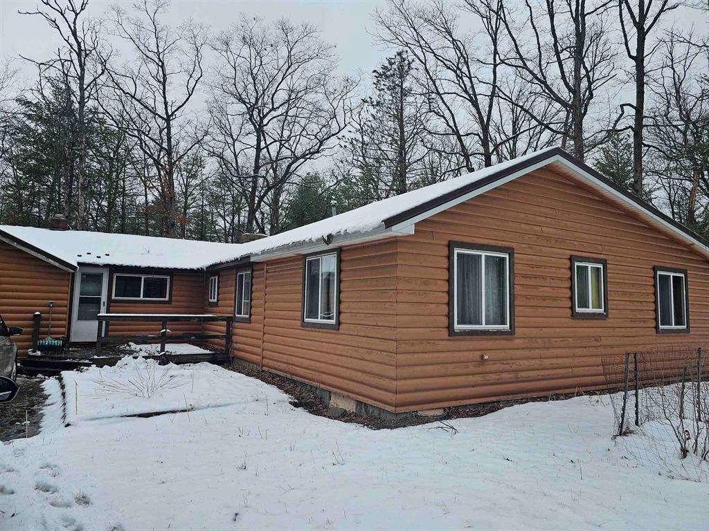 Great opportunity, this home needs some TLC to show its full potential. Located between Chain Lake and the National forest. Close to ORV and snowmobile trails. This home is 3 bedrooms and 1 bath with extra space for bath or bedroom. Beamed ceiling and fireplace in living room. 24 x 32 two story garage. Walking distance to Chain Lake Park. Family is in the process of cleaning out years of treasures.