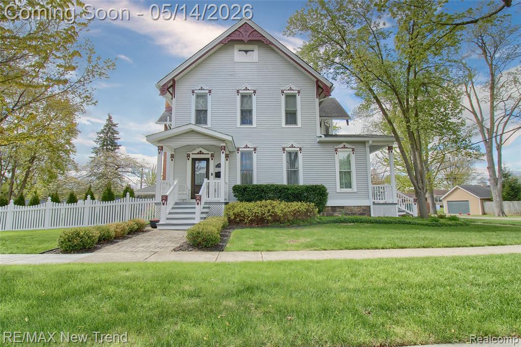 Stunning 1910 historic home fully updated with modern amenities while preserving original charm. Features hardwood floors, custom millwork, and 10' ceilings with crown molding throughout. Offers 5 bedrooms, including rare 1st and 2nd floor ensuites with heated bath floors, plus 4 full and 2 half baths. Chef's kitchen with oversized island, custom cabinetry, granite counters, and tin ceilings. (also in library). Finished basement with wet bar and wine cellar. Dual laundry in basement and 2nd floor. Situated on a double lot with a private outdoor retreat featuring hardscape patio, pavillion, fire pit, and vinyl privacy fence. 4-car garage. Four-season sunroom completes this exceptional home.