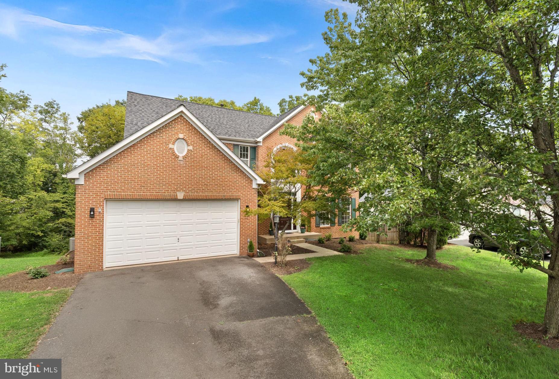 Welcome Home! Updated 4BR Brick front beauty perfectly situated on a premium, private cul-de-sac lot backing to deep woods! This 4BR Colonial in Ashburn's desirable Ryans Ridge community offers a functional layout, airy 9' ceilings on all levels, updates galore including all new flooring and paint throughout, and a convenient location close to Metro, shopping, dining and schools!  A new front door opens to an impressive and open two-story foyer with just-refinished hardwoods floors, elegant staircase, powder room and coat closet. Formal living and dining rooms with moldings, bay window and new carpet lead to the updated eat-in kitchen with new Calacatta Stream Gold Quartz countertops on the perimeter and central island, and sleek appliances. The morning room bumpout and spacious family room with gas fireplace both allow flexible, open living and entertaining. Upstairs, you’ll find four spacious bedrooms all clad in new luxury carpet, and two full bathrooms, including a comfortable primary suite with plenty of room to unwind. The unfinished walk-out basement allows you to design your own space as you wish and opens to a wood patio, and oversized 2-car garage with recessed storage space leads to the laundry room with washer, dryer and new flooring. Additional highlights include a brand new water heater July 2026, new attic insulation, all new lights, new faucets and fixtures, new lux carpet, just-refinished HWFs, New LVP tile in kitchen, laundry and bathrooms, and replaced roof. Enjoy a rare combination of a stellar commuter location, with a serene, private lot to watch nature from your large wood deck or from the patio below. Privacy abounds here at Sperrin Ct!
