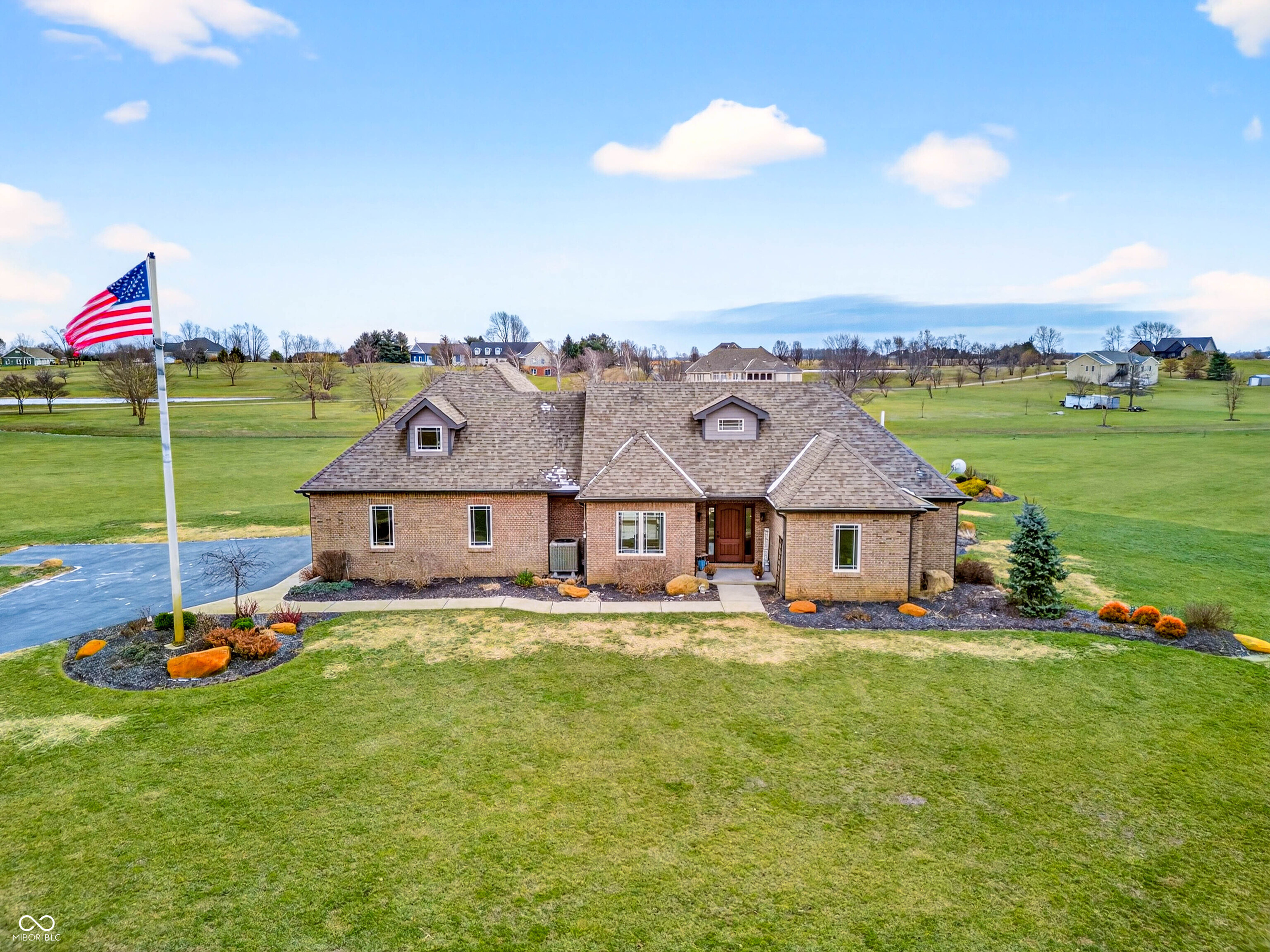 Refined craftsmanship, thoughtful design, and expansive acreage converge in this exceptional custom brick estate set on 5.4 beautifully landscaped acres. Ideally positioned on a corner lot along State Road 135, this residence offers privacy and presence just minutes from the growing town of Bargersville and the charm of Trafalgar.    The home features three spacious bedrooms plus an office, with a partially finished upstairs offering the opportunity to create a fourth bedroom or private sitting area, and additional bath-already plumbed and ready for completion-along with generous storage. Inside, natural stone flooring anchors the main living spaces, while Marvin windows flood the home with natural light and showcase views of the surrounding countryside. A statement fireplace serves as a focal point, with a separate gas hookup available for those who prefer it. The chef's kitchen is outfitted with premium Viking appliances, blending luxury and functionality for everyday living and elegant entertaining. Modern efficiency is seamlessly integrated throughout the home with spray foam insulation in key areas, an oversized humidifier, water purification system, and all-electric design. High-speed internet ensures connectivity without compromise. Designed with future comfort in mind, the property includes electrical in place for a hot tub, sidewalks plumbed for heated sidewalks, and well and septic systems. Mature landscaping, smaller trees, and shrubs enhance the natural setting, creating a serene outdoor environment with endless possibilities. This distinctive property offers an all brick ranch, rare acreage, superior construction, and refined amenities-an extraordinary opportunity for those seeking luxury, flexibility, and long-term value in a rapidly growing area.