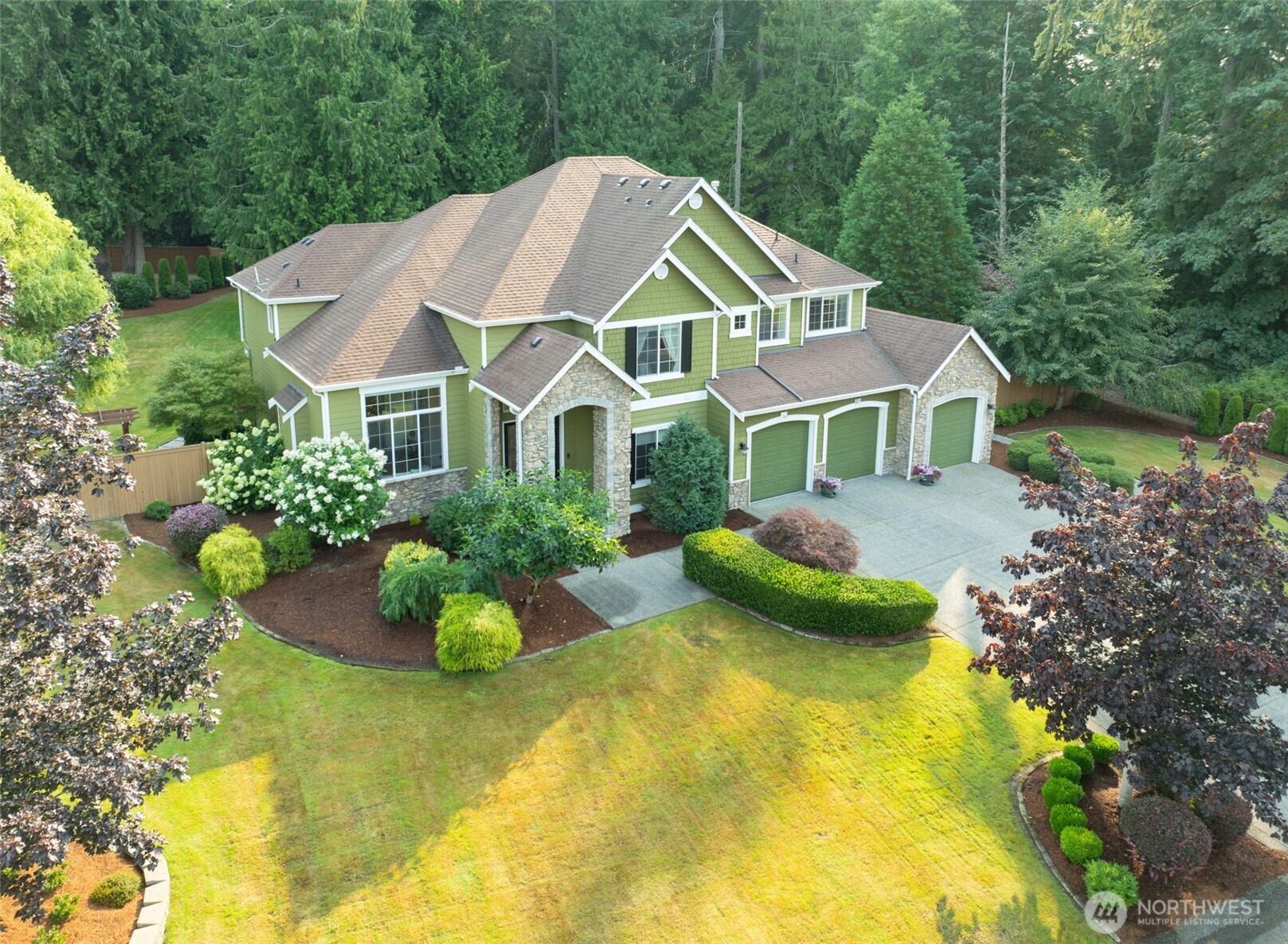 Nestled on a quiet private acre in Marysville's premier community, Aspen, this exceptional home pairs timeless architecture with picture-perfect grounds. Over $200,000 in recent refinements include new landscaping, fencing, a screened porch, entertainment center, water heater, blinds, refrigerator, washer/dryer, leaf filter system, and dishwasher. A graceful entry welcomes you with soaring ceilings and sweeping curved and elegant staircase. The main level offers a private office, formal living room with elegant gas fireplace, formal dining room, a well-appointed powder room and laundry room. The gourmet kitchen is a showpiece, featuring double ovens, gas cooktop, granite counters, and an inviting island/eating bar—flowing effortlessly into the sunlit eating nook and family room, with the 2nd fireplace and custom entertainment center. Beyond, a luxurious screened porch (414 additional sf) extends the living space outdoors, ideal for expanded entertaining. Upstairs, 4 bedrooms include a luxurious primary suite with a 5-piece bath, walk-in closet, and private sitting area, complemented by a versatile bonus room and a convenient back staircase. Don't miss the Juliette balcony in the 2nd bedroom with 3/4 en-suite bathroom. Central A/C & a whole house generator.  Surrounded by manicured, sprinkler-irrigated grounds and lovely views from every window, this is a home where elegance meets ease of living—an invitation to entertain, unwind, and live beautifully. Green space & LOCATION.