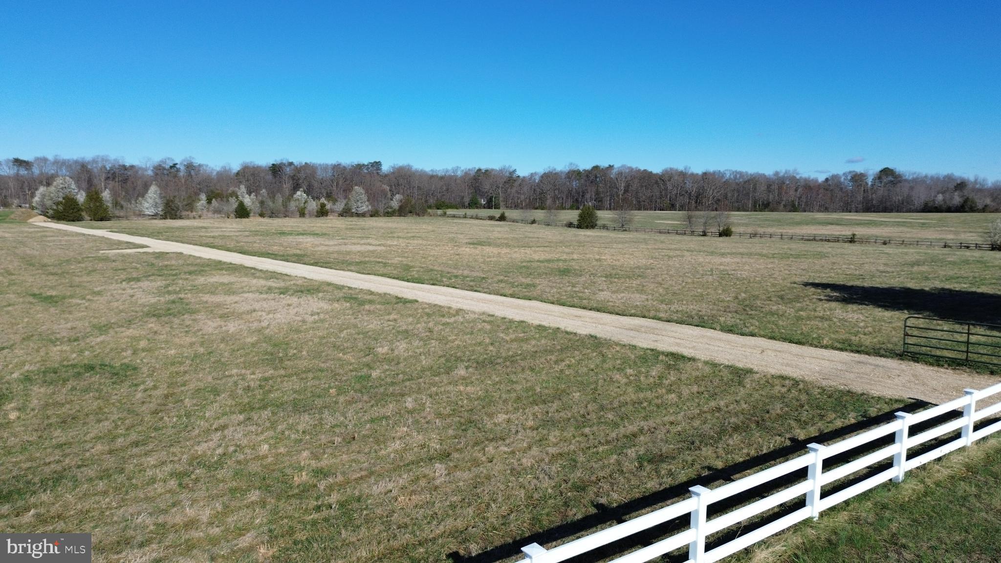 Located in the heart of Spotsylvania, this exceptional 6.25-acre parcel stands out as the largest of four sister lots—offering a rare combination of space, privacy, and potential. Tucked away from the congestion of city traffic yet just minutes from everyday essentials like shopping, dining, healthcare, and top-rated schools, this property strikes the perfect balance between peaceful living and modern convenience.Set back off Hickory Ridge Road and accessed via the newly established Whispering Meadow Trail (complete with street signage to be installed), the homesite provides a sense of seclusion while remaining easily accessible. With minimal light pollution, you’ll enjoy stunning night skies—ideal for stargazing and unwinding under the stars.The lot has already been evaluated for a septic system, giving future homeowners a head start on building their dream residence. Three additional 3+ acre adjoining lots are also available, creating even more opportunity for expansion, multi-generational living, or investment.What truly sets this property apart is the existing barn—a standout feature full of potential. With six stalls, a tack room, wash stall, and hay storage area, it’s perfectly suited for equestrian use or hobby farming. With a bit of vision and effort, this structure can be transformed into a functional and valuable asset, especially with A3 zoning in place to support agricultural pursuits.Whether you're envisioning a private estate, equestrian retreat, or long-term investment, this property offers the space, setting, and flexibility to bring your vision to life.*Spotsylvania GIS shows inaccurate location. Main asphalt driveway belongs to neighboring property; the gravel road is Whispering Meadow Trail.