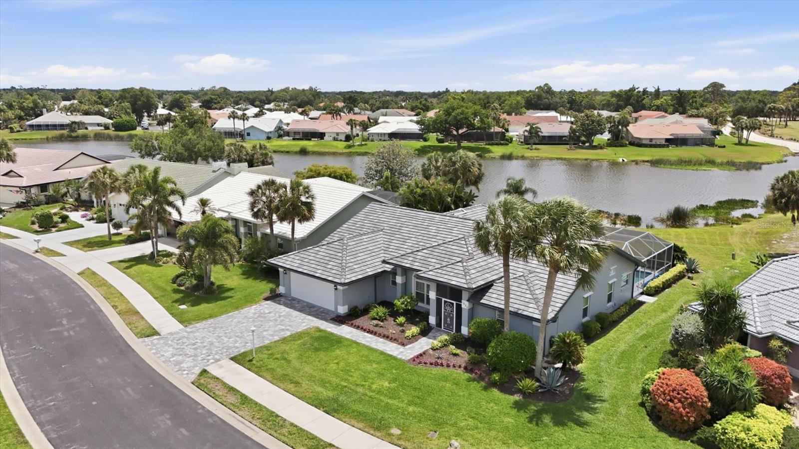 Set within the gated Waterford community of Venice, this well-maintained pool home offers relaxed Florida living with an expansive water view located near the golf course. Mature tropical landscaping, a custom paver entrance, and fresh exterior paint create pristine curb appeal, while a 2023 tile roof adds long-term peace of mind. Inside, high ceilings and sliding glass doors fill the home with natural light connecting living spaces to the extended screened lanai. The covered porch with all new outdoor fans offers the perfect setting for entertaining while enjoying tranquil water views. The solar-heated pool (resurfaced 2025) enhances the outdoor living experience, ideal for year-round enjoyment. The kitchen features granite countertops, solid wood cabinetry with abundant storage, and a large breakfast bar open to the family room. The home also offers an additional living room plus a formal dining room, providing flexible spaces for gatherings. The primary suite includes dual sinks, a soaking tub and shower, and two walk-in closets. One of the guest bedrooms features a Murphy bed, while the other easily functions as an additional guest room or office. Further highlights include a 2-car garage finished with epoxy flooring, Plantation shutters throughout for timeless style, and hurricane shutter protection. Lovingly maintained, the property is offered furnished and move-in ready. Residents of Waterford enjoy amenity-rich offerings and optional golf membership with tennis courts, a Club house, heated pool and fitness center, all just minutes from historic downtown Venice and coastal beaches.