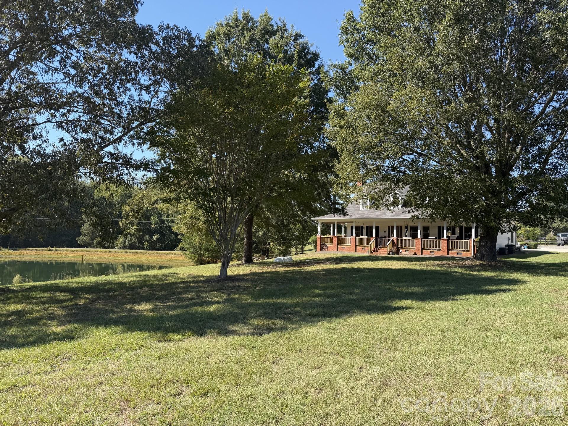 Experience the best of country living on this beautiful 11.89± acre fenced horse farm, just minutes from downtown Waxhaw! Featuring a 1 acre private stocked pond, a charming 3-bedroom, 2.5-bath home with a spacious front porch, and an impressive 96' x 36' horse barn with a wash stall, feed room, and 12 additional stalls. Additional amenities include a detached 3-car garage, climate-controlled office, metal storage sheds, chicken coop, and trailer storage. Privacy, functionality, and country charm—all in one incredible property! Whether you're an equestrian enthusiast, hobby farmer, or simply dreaming of a peaceful country retreat, this special property is a must-see!
