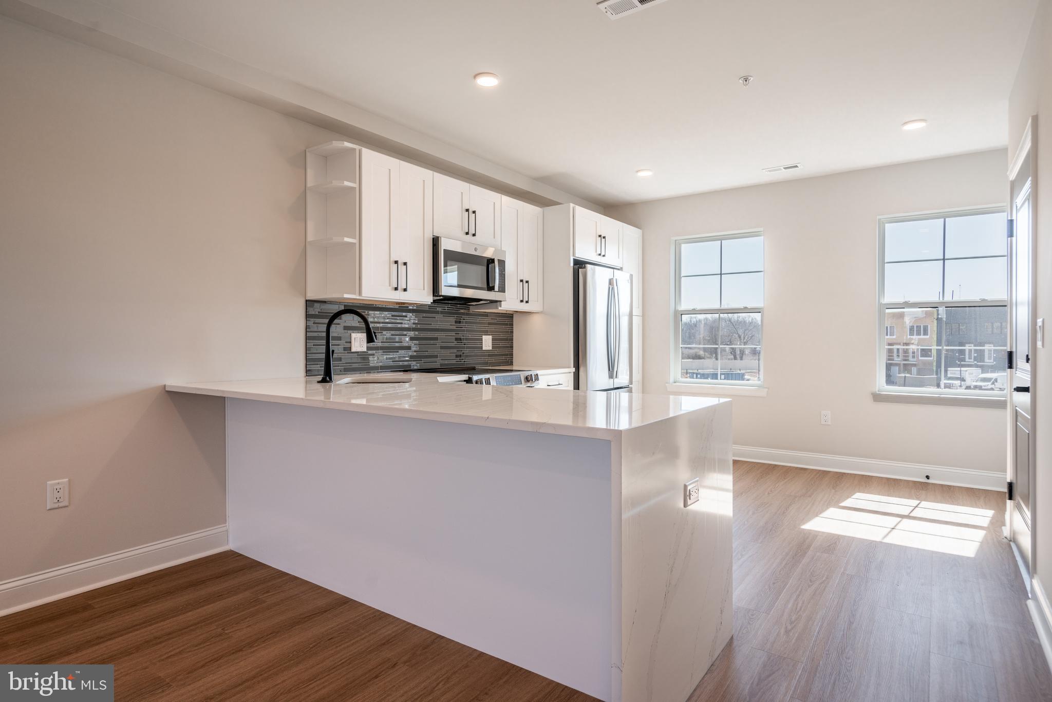 *HOMEBUYER LOAN PROGRAM OFFERING 100% FINANCING, $5,000 LENDER CREDIT AND NO PMI.* Welcome to your dream home nestled in the private community of Wynnefield Heights Square. This chic residence boasts 2 spacious bedrooms and 2 modern bathrooms, all enveloped in the comfort of an energy-efficient HVAC system. Step inside to find a meticulously crafted kitchen featuring Quartz countertops with a waterfall edge, Stainless steel appliances, and under-cabinet lighting - bringing warmth and functionality to your cooking space. Natural light floods the space, highlighting the thoughtful details like wood baseboard molding, glass railing, and high end vinyl flooring. The chic exterior combines brick and standing seam metal on the mansard roof, enhancing the building's charm and curb appeal. Fully approved 10-year tax abatement promises affordability. The cozy PRIVATE ROOF DECK will serve as a serene spot for you to enjoy the beautiful evening sunsets with a glass of wine. Assigned outdoor parking is available for $30,000, ensuring your vehicle's security just steps from your door. Available Summer of  2026. Your oasis in Wynnefield Heights Square awaits. PHOTOS ARE OF AN IDENTICAL UNIT IN THE DEVELOPMENT.