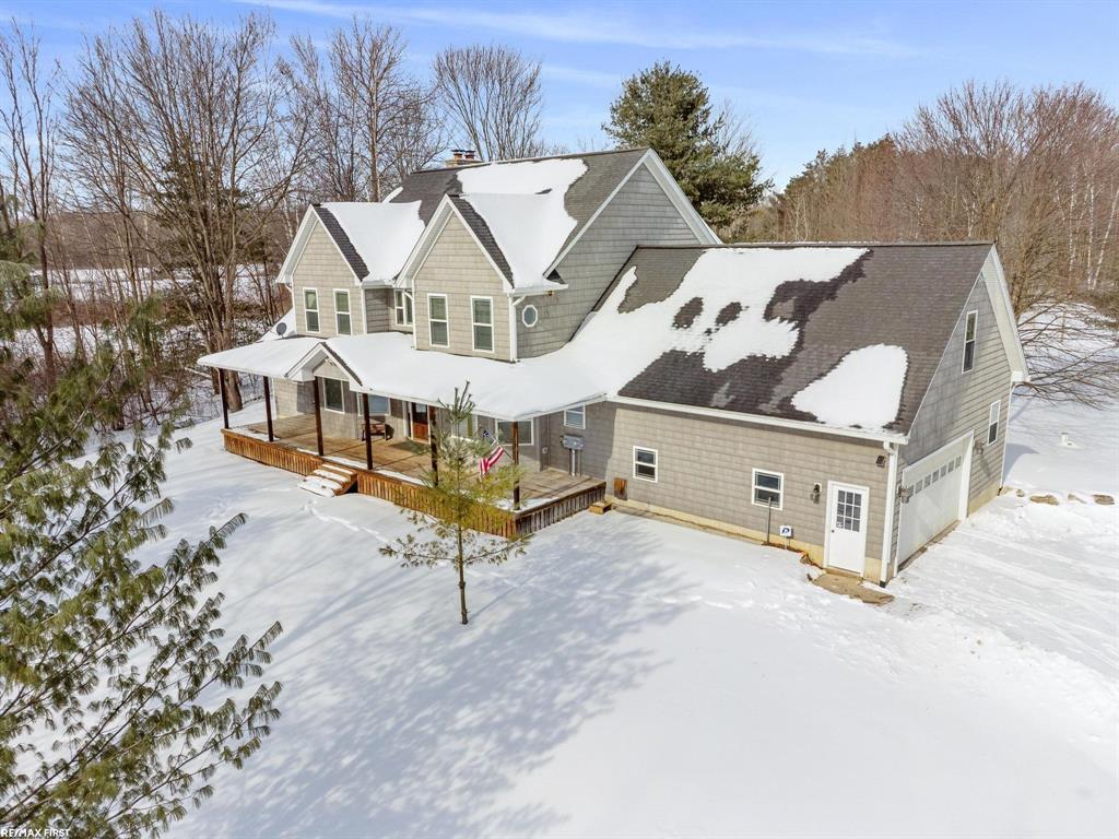 Set several hundred feet from the road on 16 beautiful acres, this exceptional estate delivers the space, privacy, and lifestyle today's home buyers crave-without sacrificing convenience. Ideally located near I-94, downtown Marysville, and Port Huron, the property offers an easy commute to work, schools, and everyday amenities while providing a peaceful country setting to explore, play, and grow.  A thoughtfully balanced mix of open land and wooded areas creates endless opportunities for recreation, gardening, trails, and outdoor gatherings. The impressive 40x60 pole barn with front and rear overhead doors, water, and electric is perfectly suited for hobbies, storage, recreational vehicles, or a home-based workspace.  Inside, more than 4,400 square feet of living space supports both comfortable daily living and memorable entertaining. The open kitchen features warm hickory cabinetry, stainless appliances, tiled backsplash, bay-windowed eating nook, and durable 3/4" hardwood floors. A formal dining room and stunning 23x22 great room with vaulted ceilings and a natural fireplace framed by a dramatic two-story stone surround provide ideal spaces for gatherings.  The first-floor master suite offers a private retreat with full bath, jetted whirlpool tub, walk-in tiled shower, dual sink vanity, walk-in closet, and direct access to the covered porch. A spacious first-floor laundry/utility room with extensive cabinetry, plus a versatile flex room (den, office, or potential 5th bedroom), add everyday functionality. Upstairs, three generous bedrooms, two full baths, walk-in closets, a glass partition overlooking the great room, and a 24x12 bonus room that can accommodate growing households with ease.  Efficiency and construction quality truly set this home apart. Geothermal heating with dedicated lower-rate electric meters dramatically reduces operating costs, complemented by 4-zone heating/cooling, 15" cellulose insulation, insulated basement foundation, engineered trusses/joists, whole-house water filtration, humidifier,