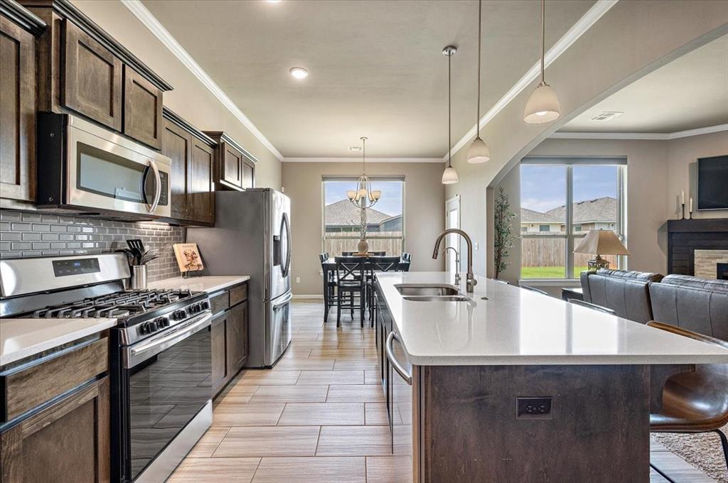 Don’t miss this beautifully designed home that blends comfort, style, and smart features — ready for you to move in and enjoy! Stunning 3 Bed + Study/office | 2 Bath | 2-Car Garage Home with Designer Touches!

*Spacious open-concept layout perfect for entertaining
*Large quartz island – ideal for gatherings and meal prep
*Quartz kitchen countertops with stylish subway tile backsplash
*5-burner gas stove for the home chef
*Gas log fireplace creates a cozy ambiance in the living area
*Tray ceilings add a touch of elegance throughout
*Remote-controlled blinds for modern convenience
*Private study/home office for productivity or quiet time
*Oversized walk-in primary closet – plenty of storage
*Luxurious primary bath with a relaxing soaker tub
*Reverse osmosis water system included
*In-ground storm shelter located in the garage for peace of mind
***Neighborhood amenities: Clubhouse, pool, gym & playground***